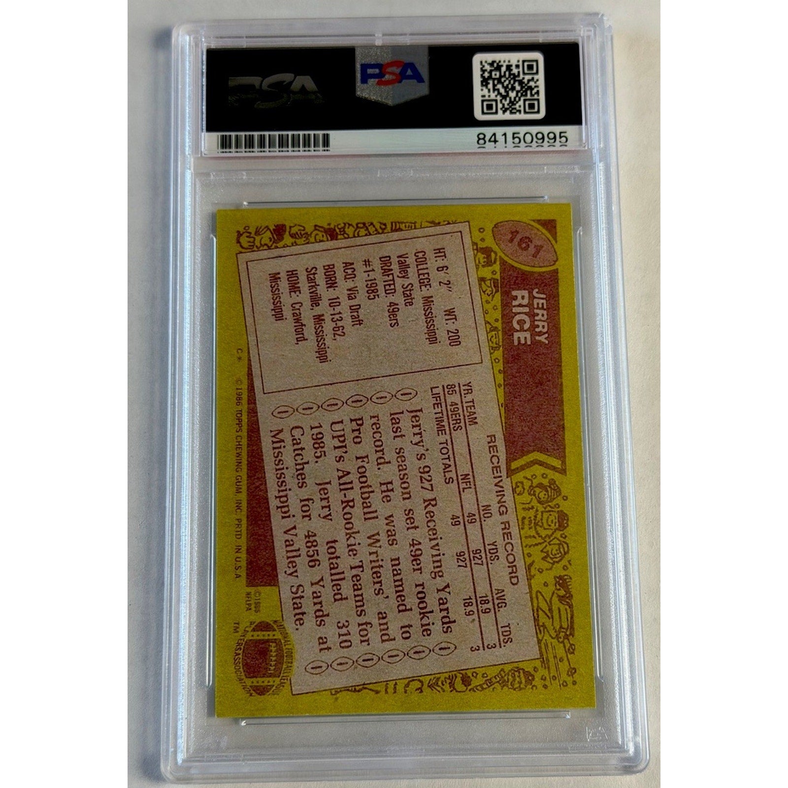 Baseball card with yellow back and clear protective case, featuring a logo and text.
