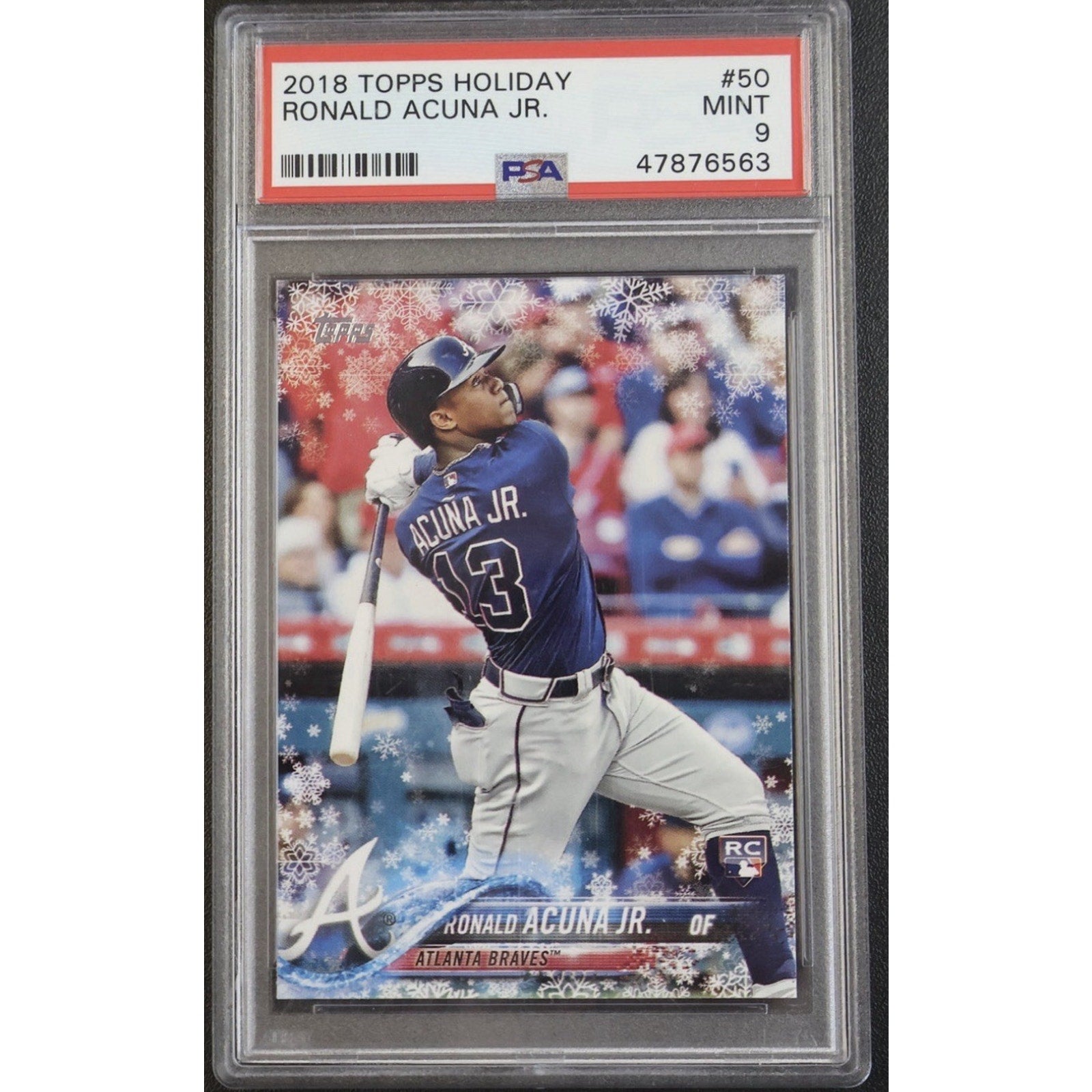 Baseball trading card of Ronald Acuna Jr. in a protective case with Topps branding.