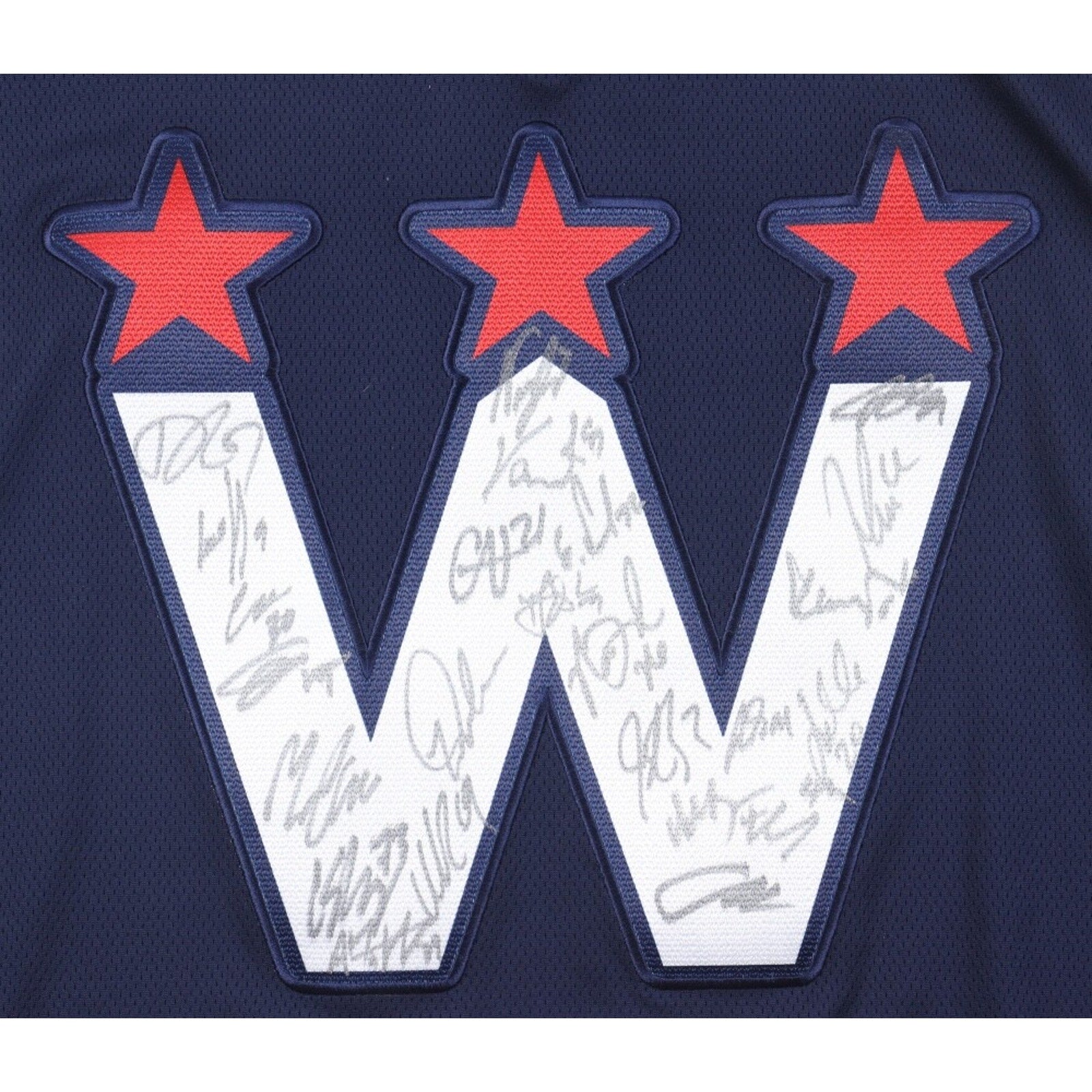 Close-up of signed Washington Capitals logo with multiple player autographs