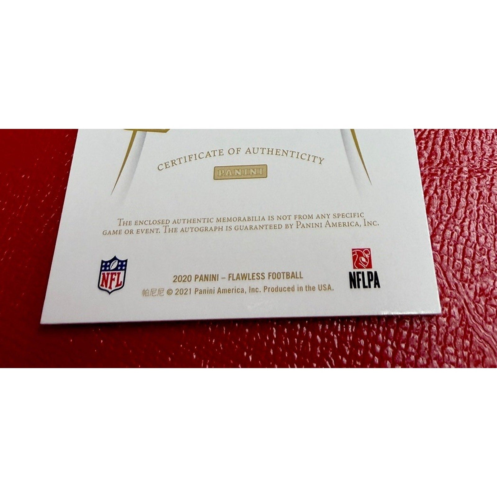 Certificate of Authenticity for 2020 Panini Flawless Football on a red textured surface