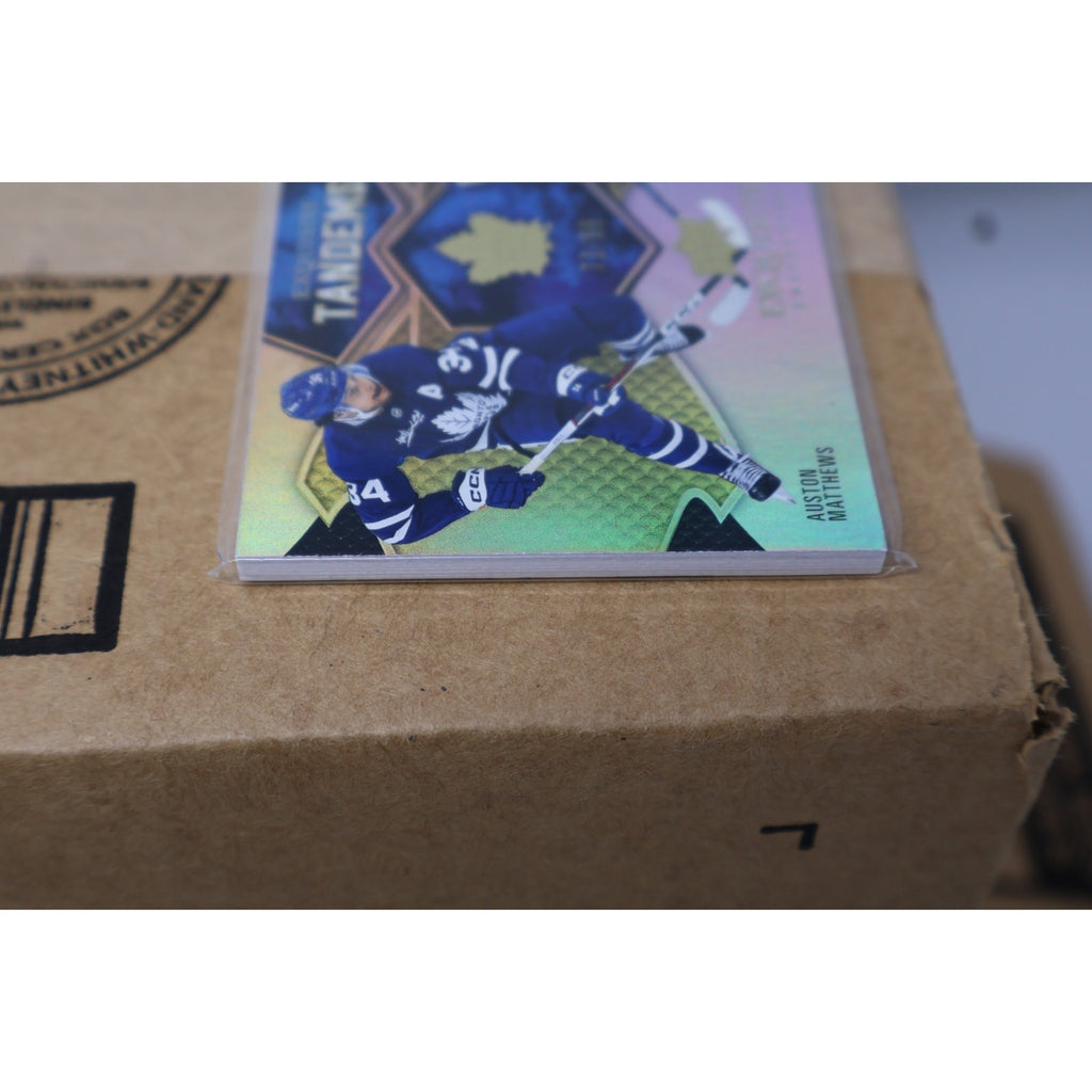 Close-up side angle of 2023-24 Exquisite Tandems Gold Maple Leafs card