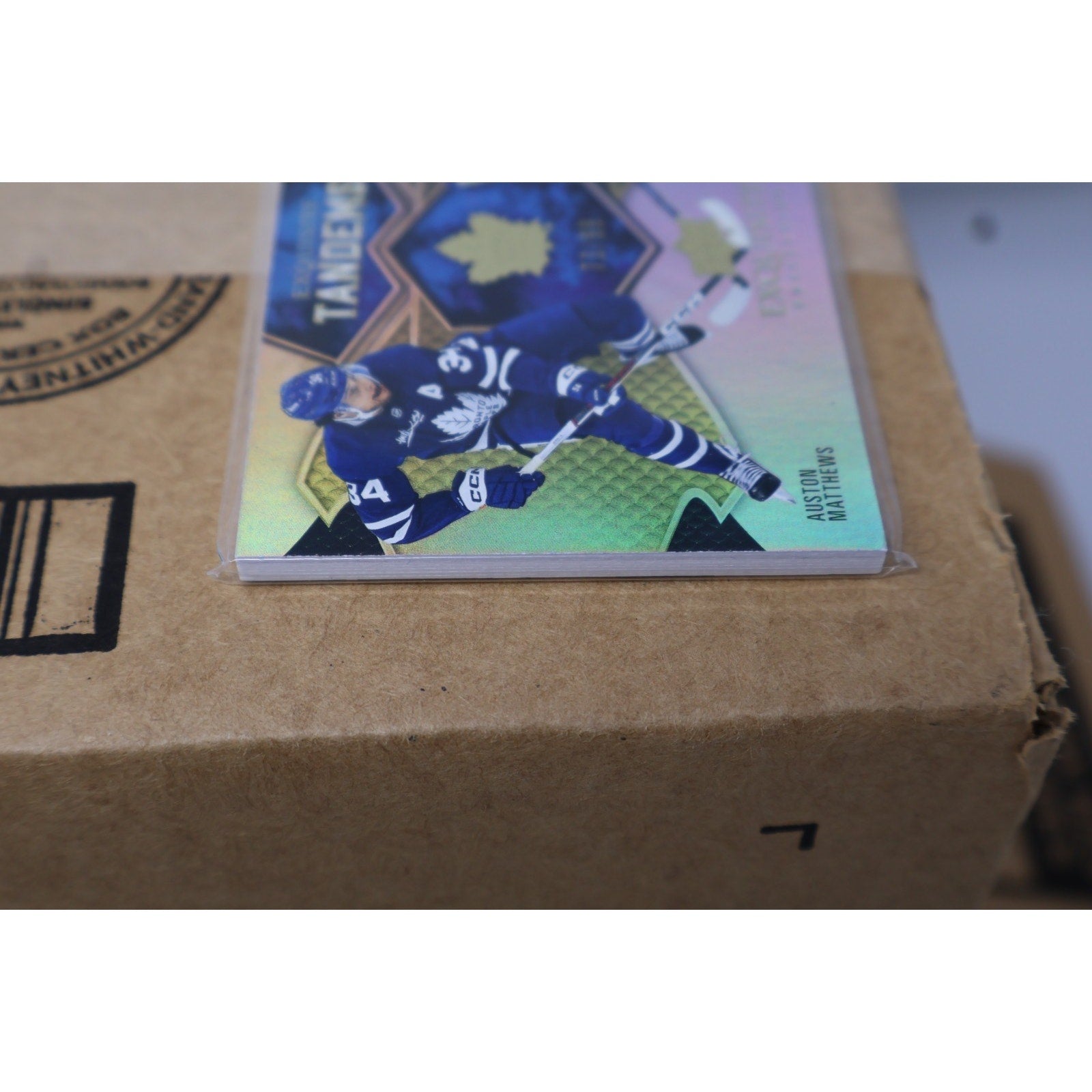 Close-up side angle of 2023-24 Exquisite Tandems Gold Maple Leafs card