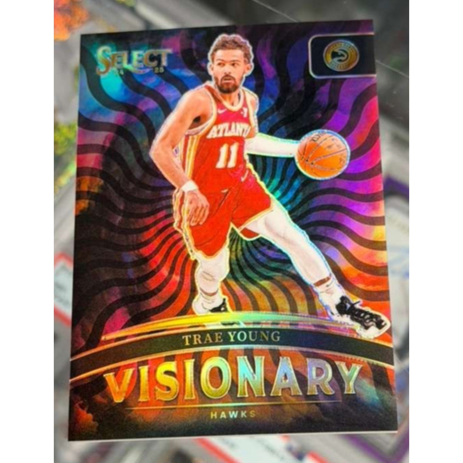 2024-25 Panini Select Visionary Trae Young #25 Atlanta Hawks insert basketball card front featuring vibrant holographic design