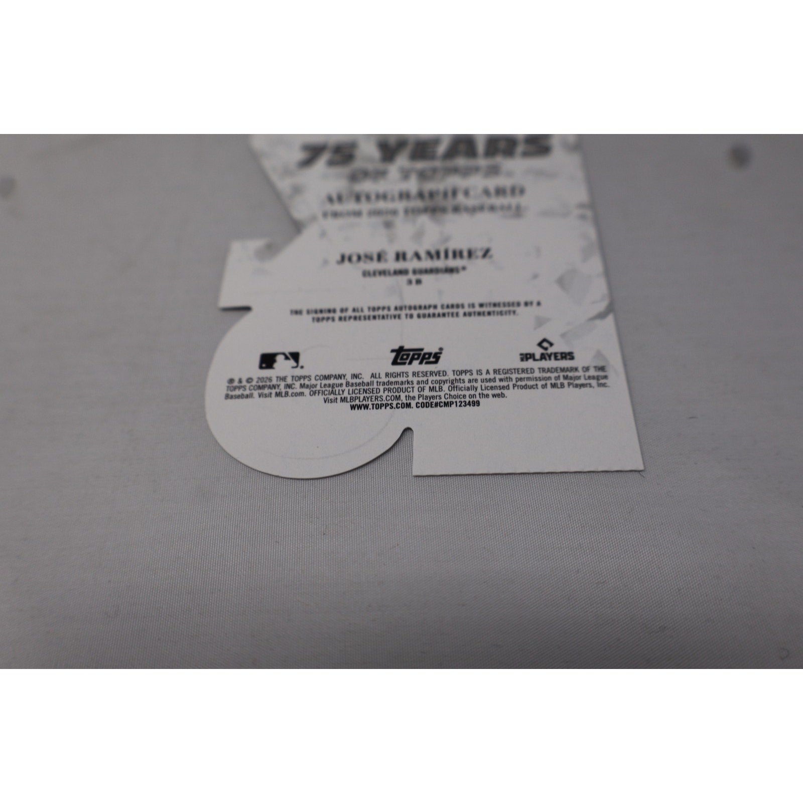 Topps trading card packaging with a card inside on a gray surface