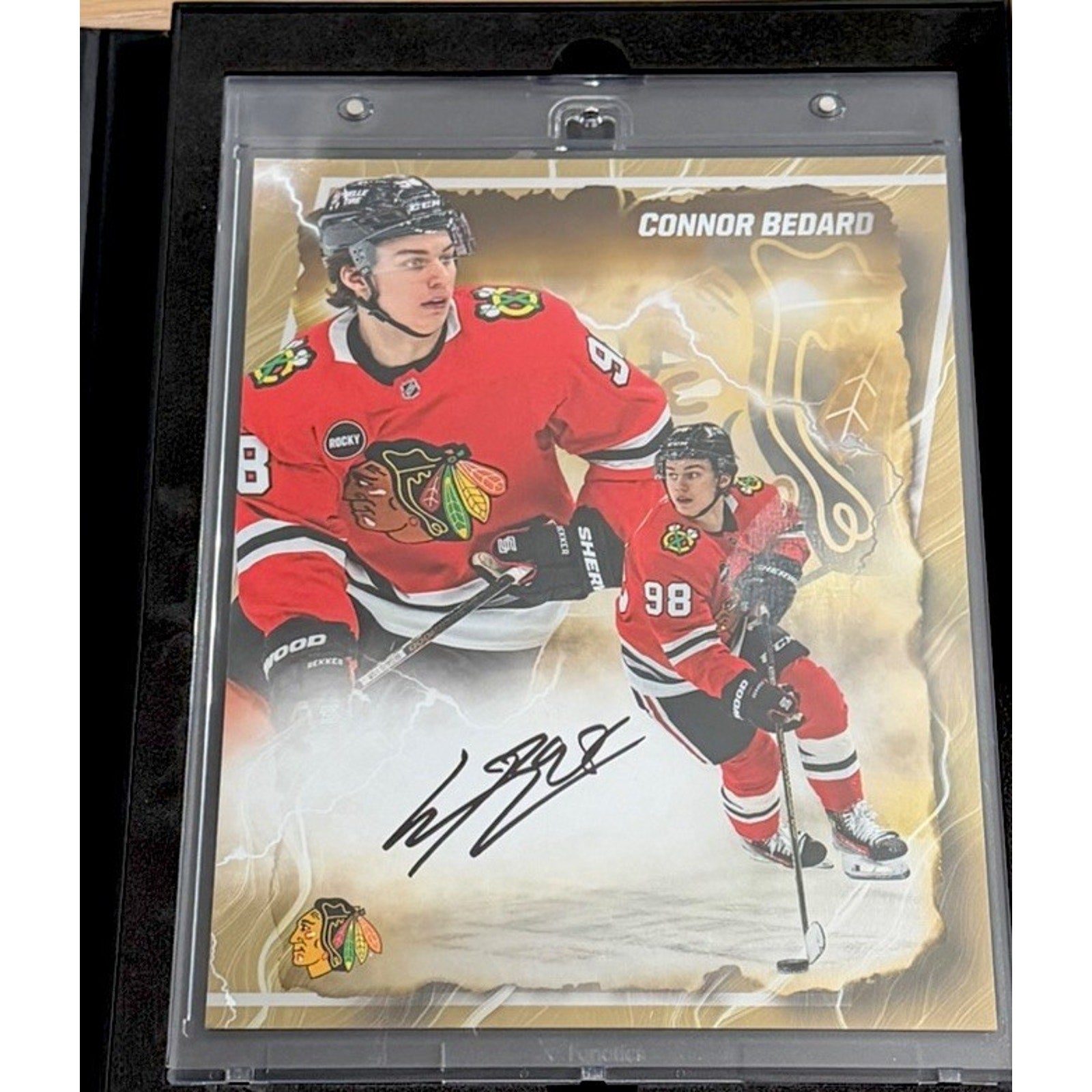 Close-up angled view of Connor Bedard signed Fanatics Emanate NHL trading card with gold foil design