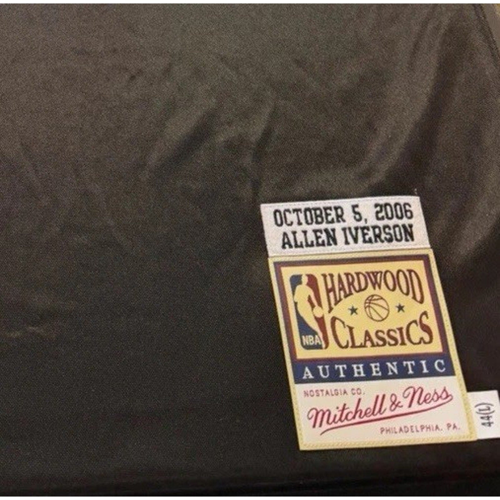 Reverse side view of Allen Iverson autographed 76ers Hardwood Classics jersey showing JSA certification and manufacturer tagging