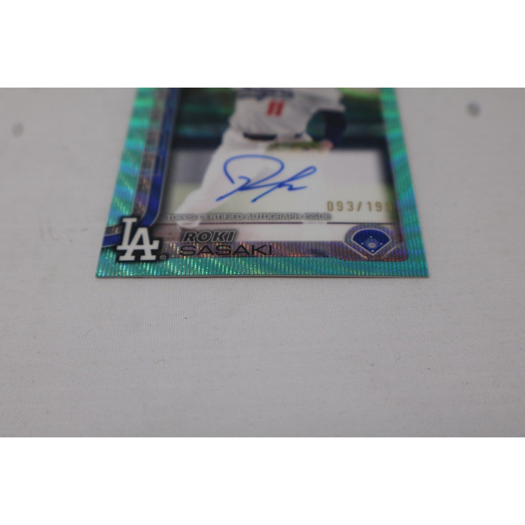 Angled front view of 2025 Topps Chrome Roki Sasaki Aqua Wave Refractor rookie autograph card