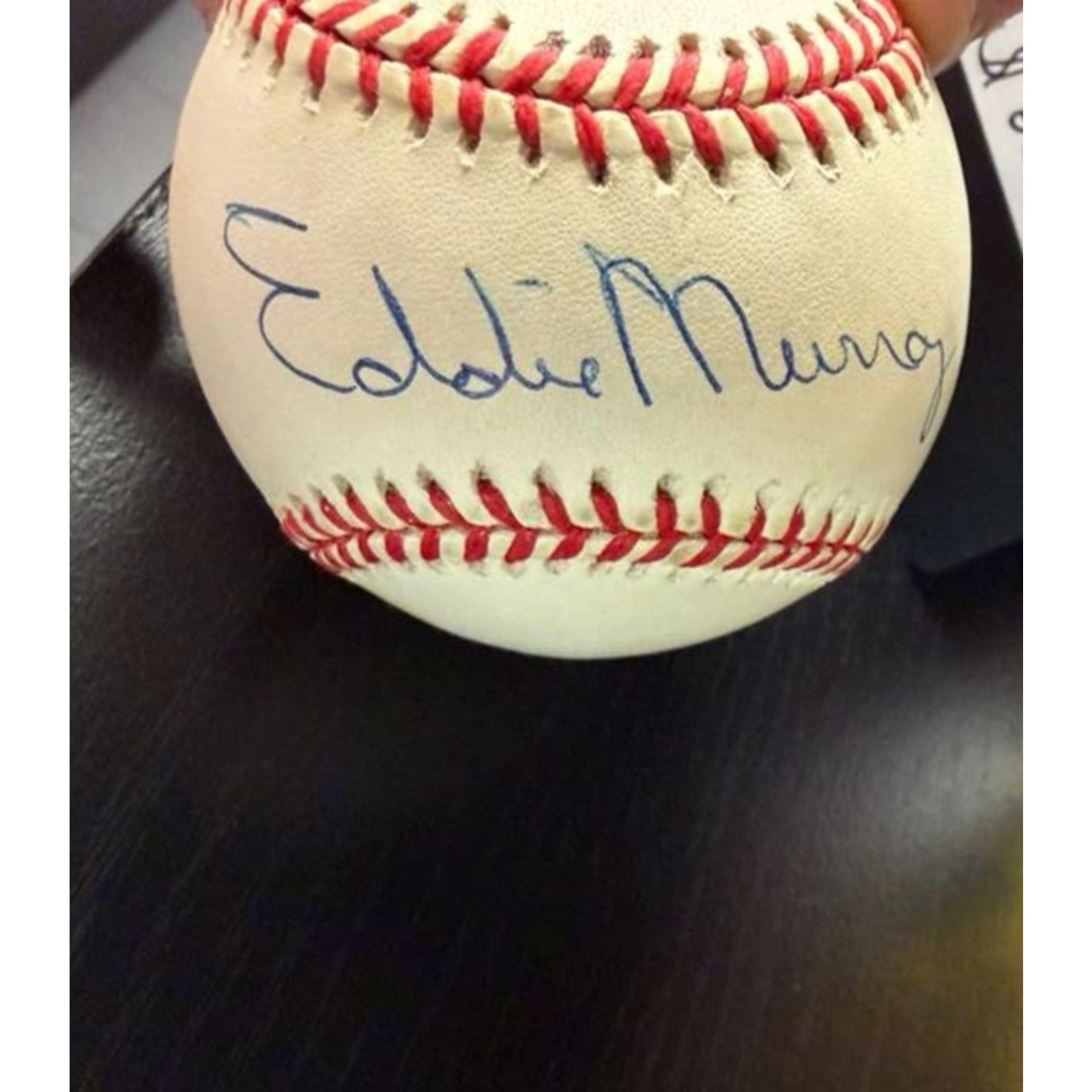 Eddie Murray autographed Rawlings OAL baseball showcasing clean signature on official league baseball
