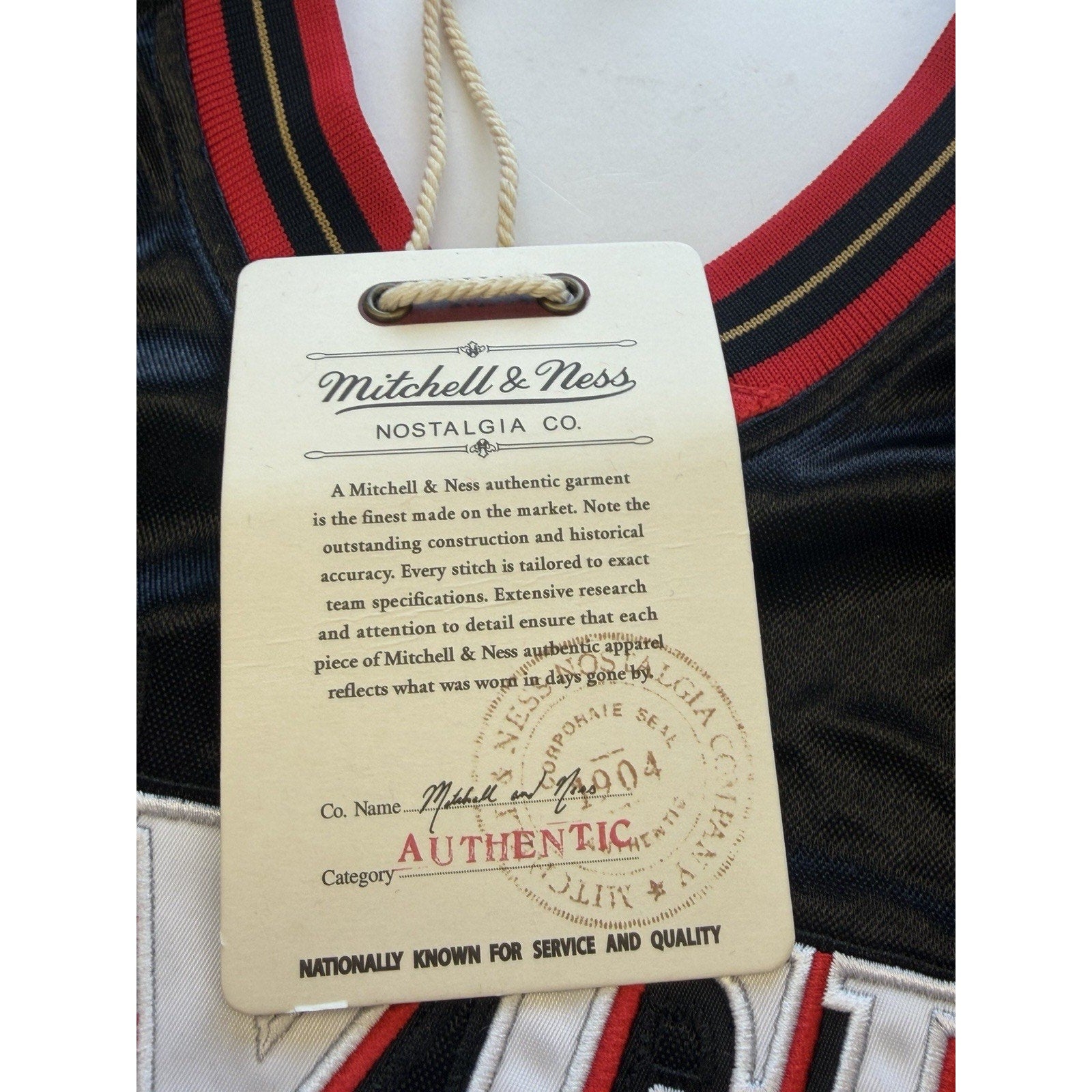 Close-up of Mitchell & Ness authenticity hang tag on Allen Iverson Philadelphia 76ers jersey