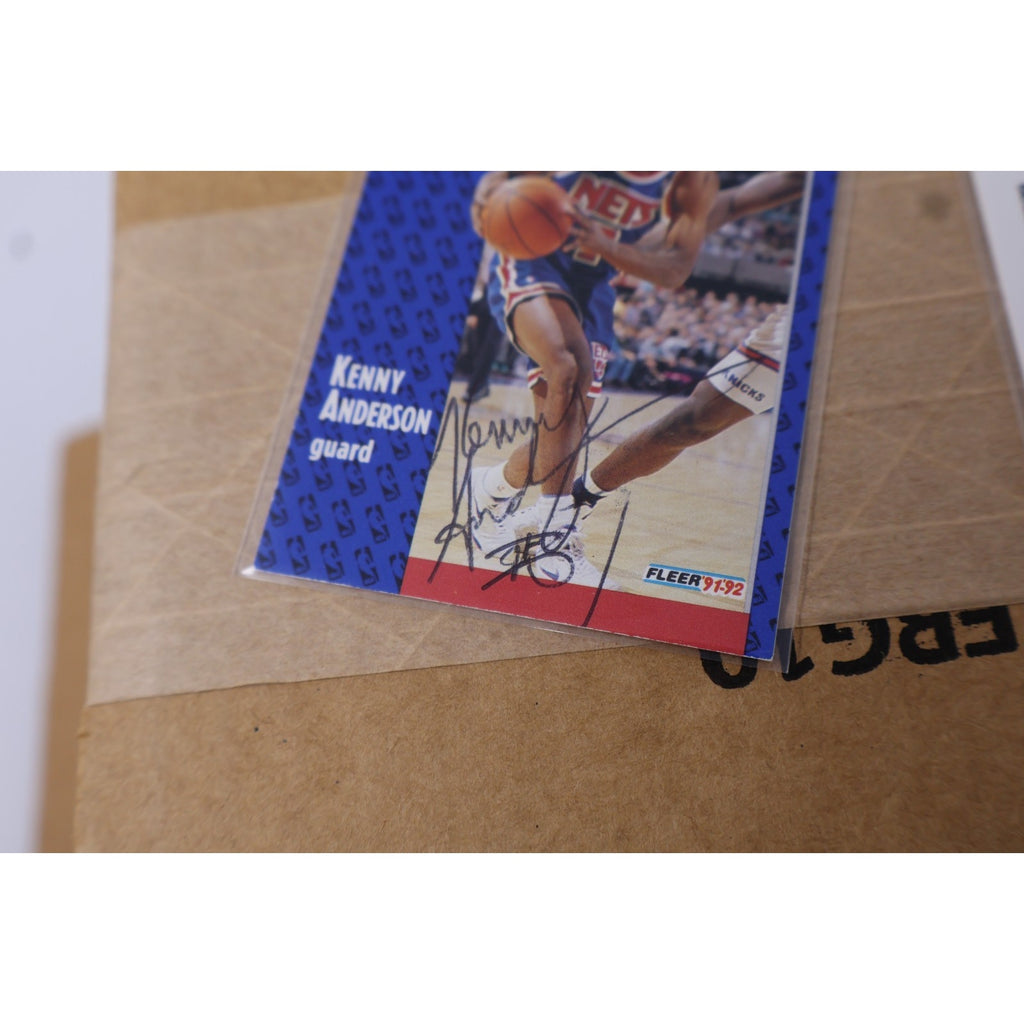 Side angle display of signed Kenny Anderson Fleer and SkyBox cards