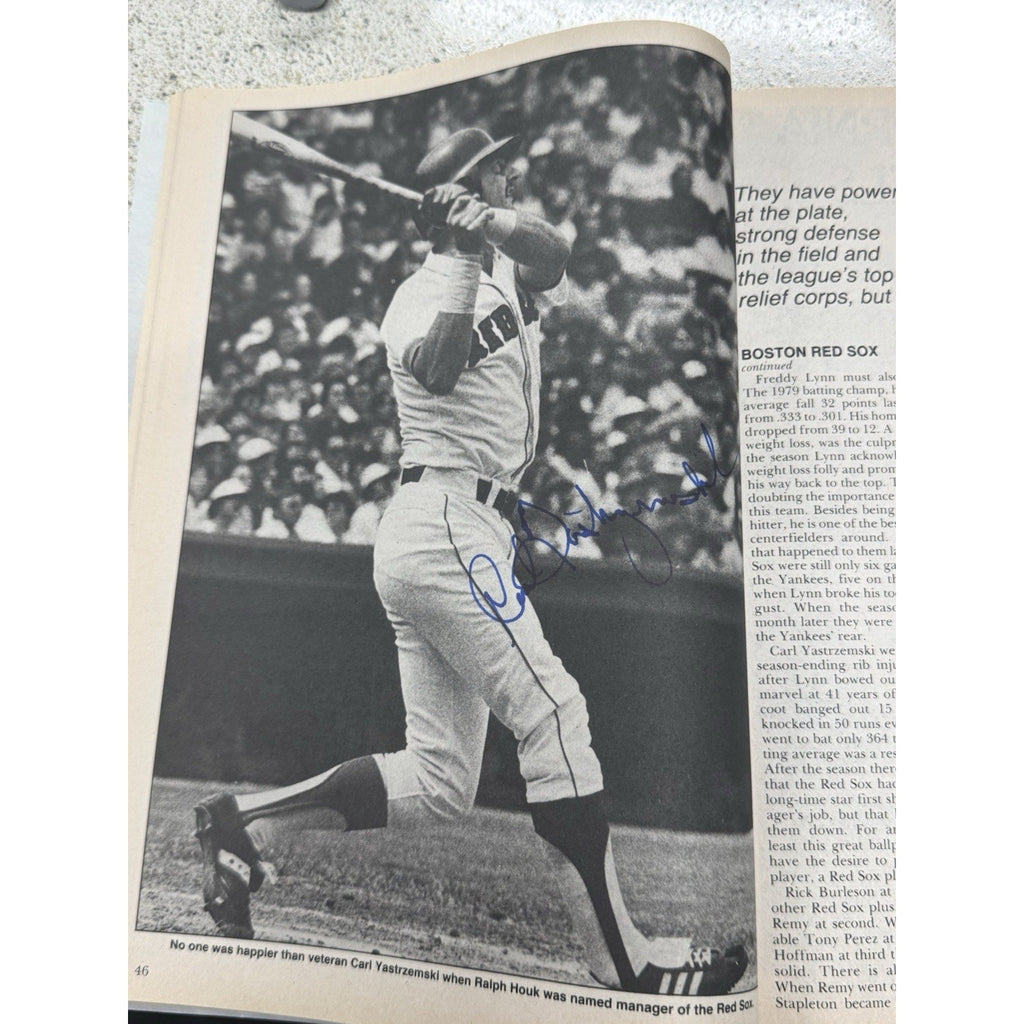 Signed vintage baseball magazine page featuring classic MLB player photography and memorabilia content