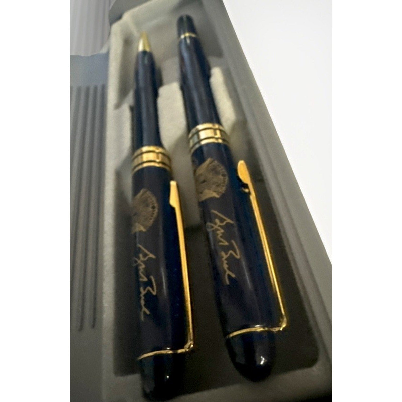Close-up angled view of authentic George W. Bush White House VIP pen set featuring Presidential Seal detailing
