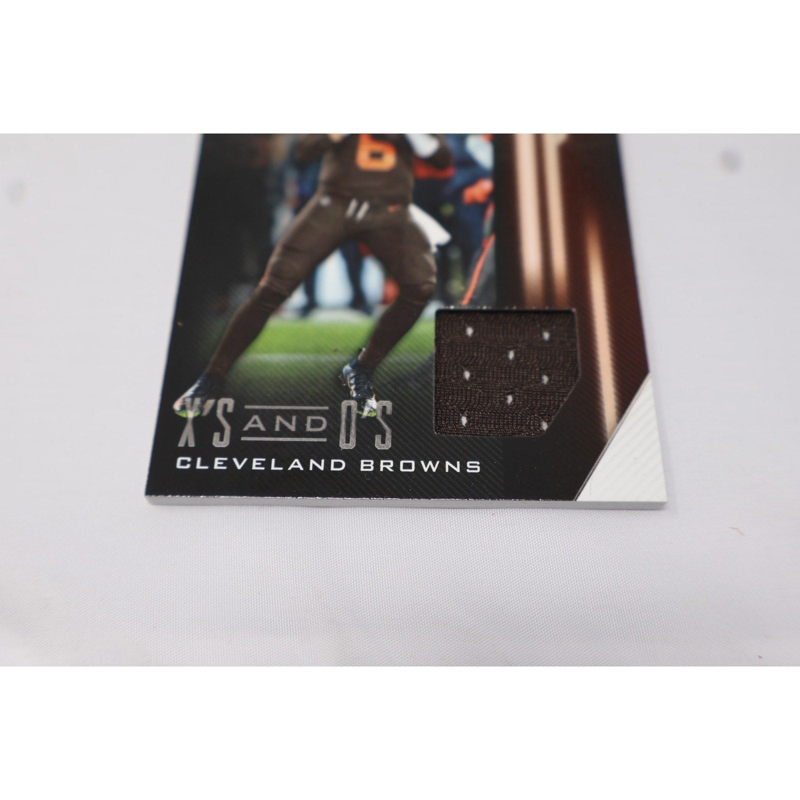 Angled front view of Baker Mayfield rookie patch card from 2018 Panini Playbook Football series