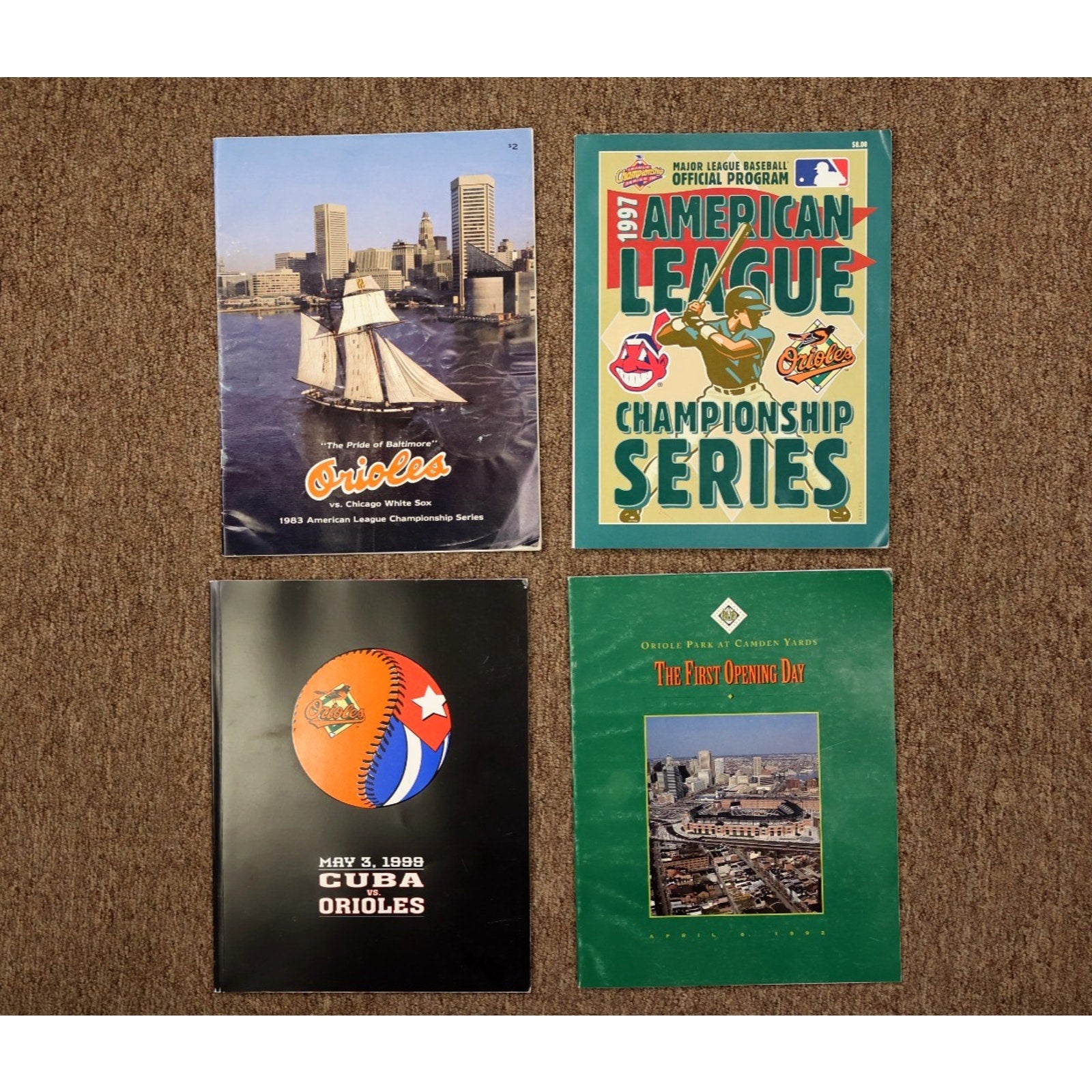 Complete lot of four historic Baltimore Orioles game day programs displayed together