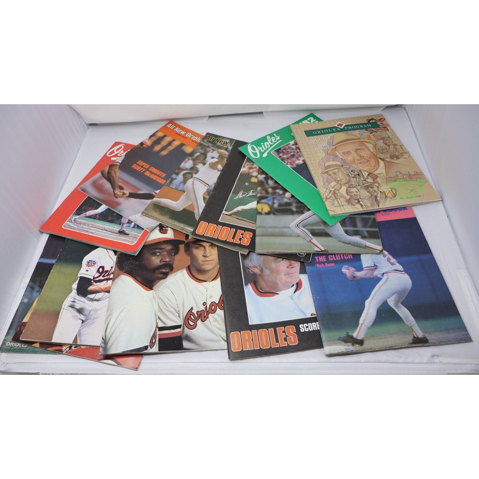 Lot of 13 vintage Baltimore Orioles scorebooks from the 1980s featuring classic MLB programs and collectible baseball memorabilia in clean condition