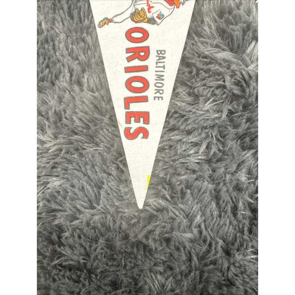 Close-up view of 1960s Baltimore Orioles mini pennant with vintage team lettering and mascot design