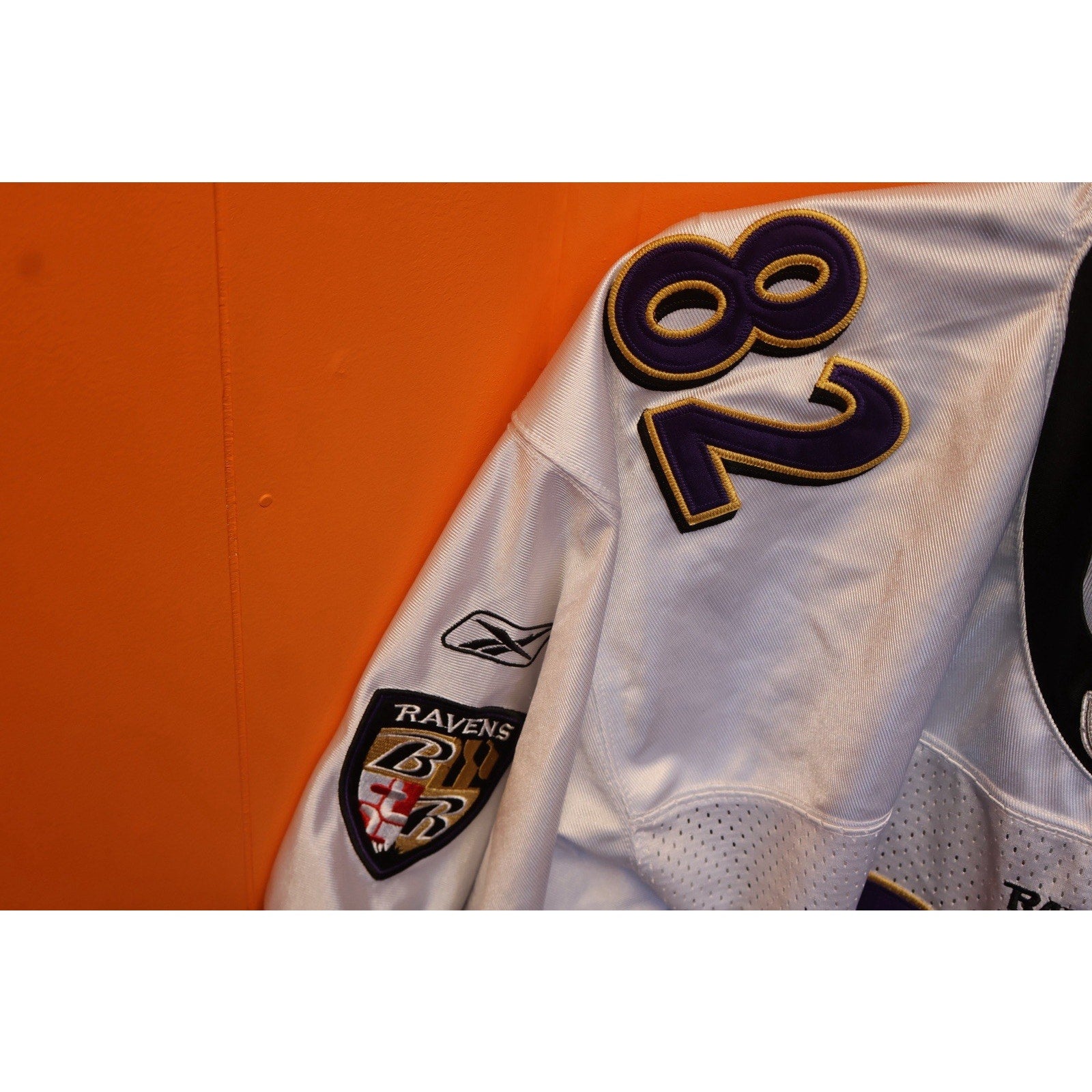 White sports jersey with number 82 on an orange background
