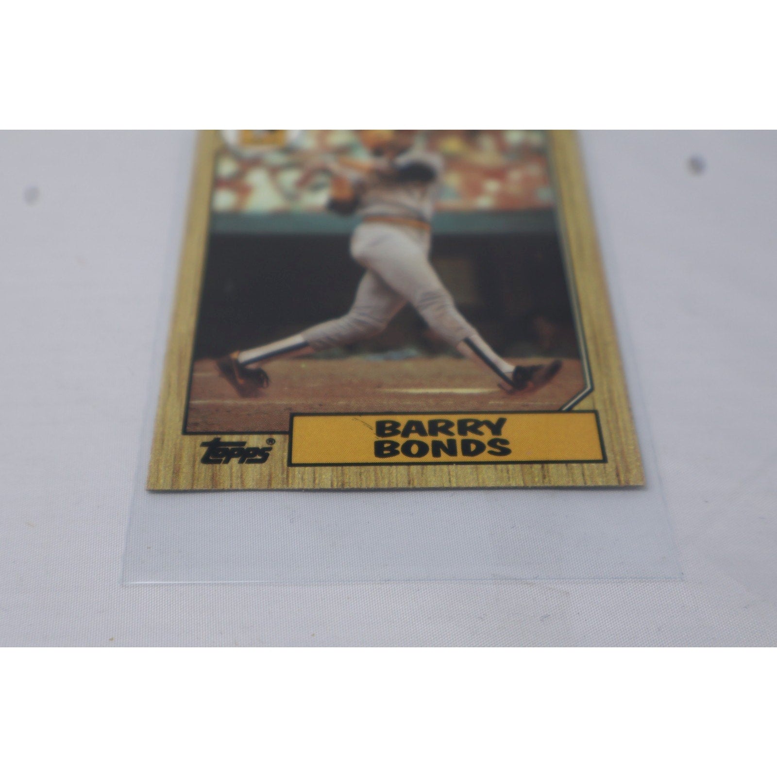 Angled front view of 1987 Topps Barry Bonds rookie baseball card #320 on display