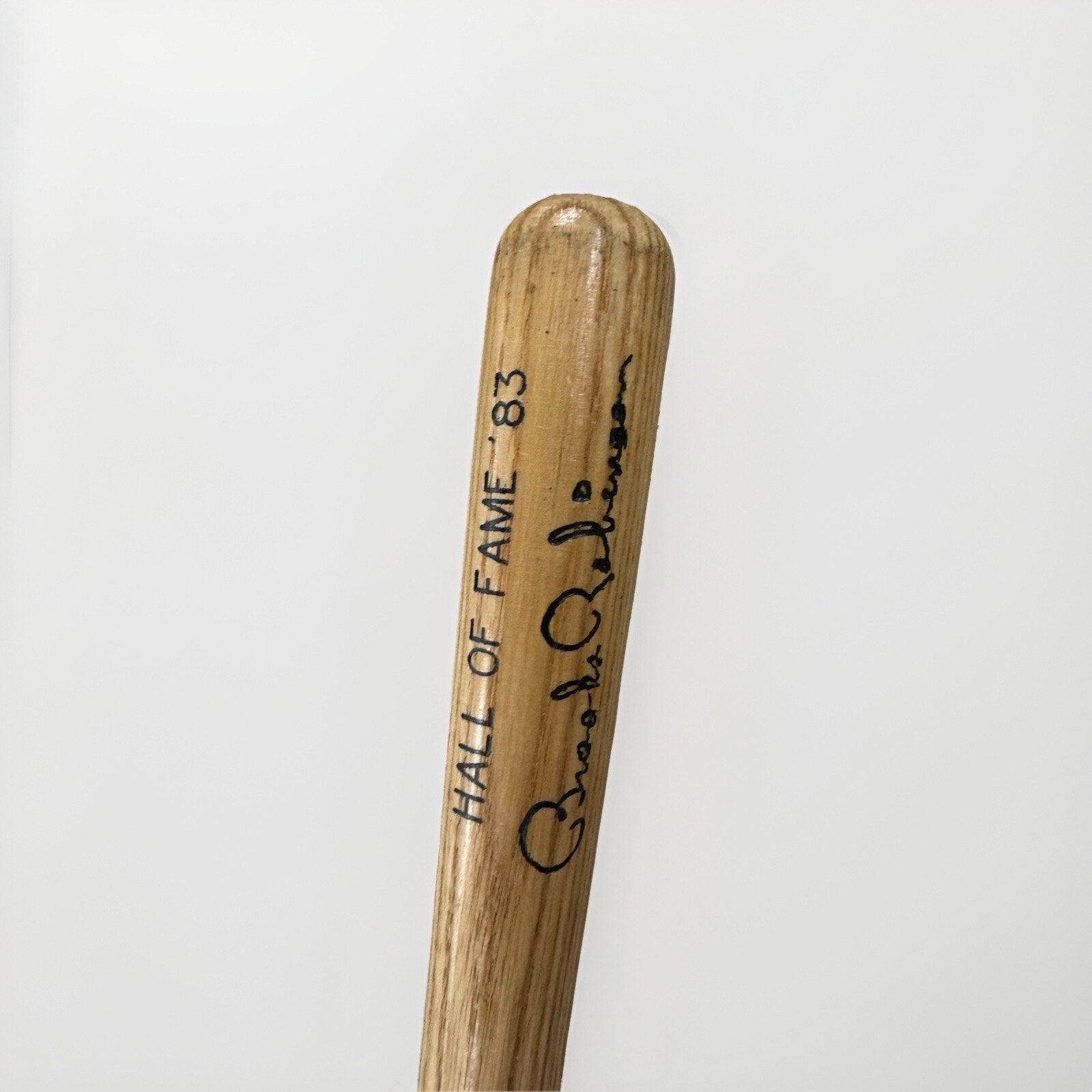 Close-up of Brooks Robinson facsimile signature on wooden mini bat