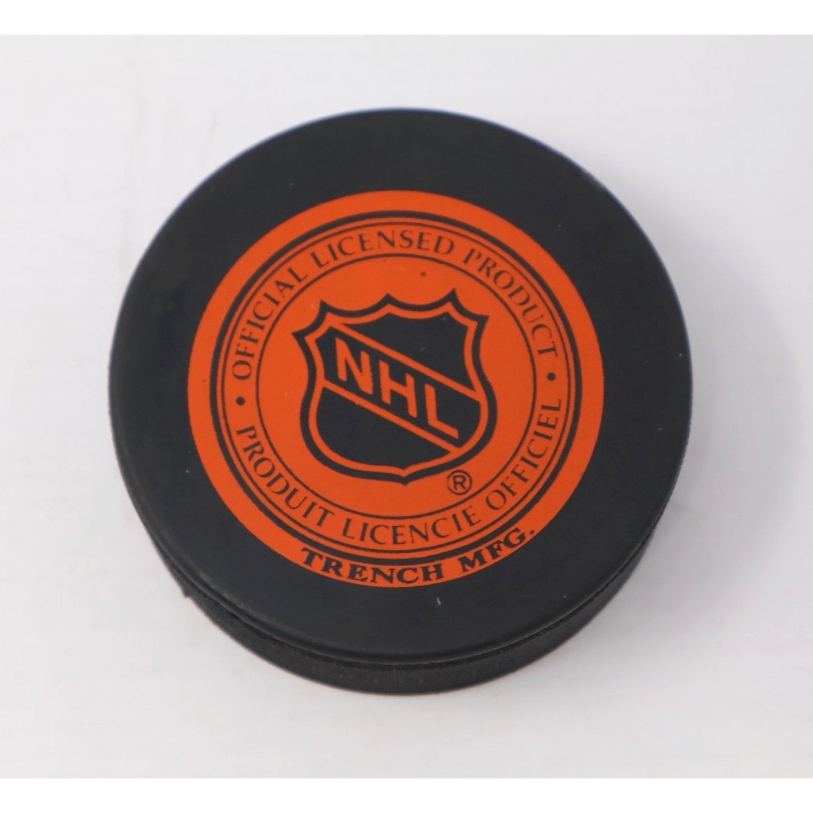 Back view of official NHL Tampa Bay Lightning hockey puck with league branding