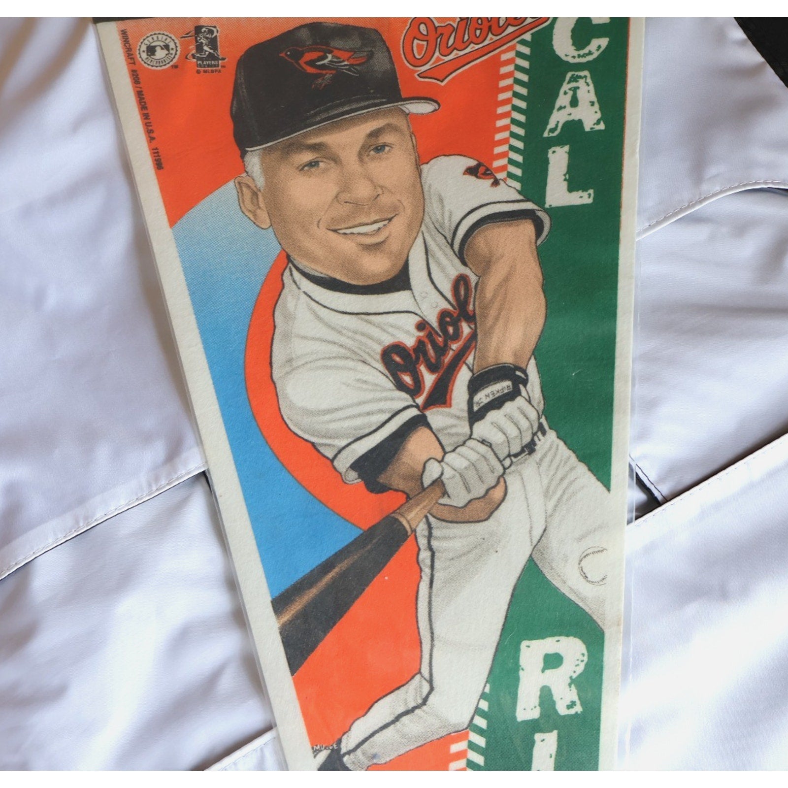 Close-up of Cal Ripken Jr artwork and Orioles graphics on felt pennant