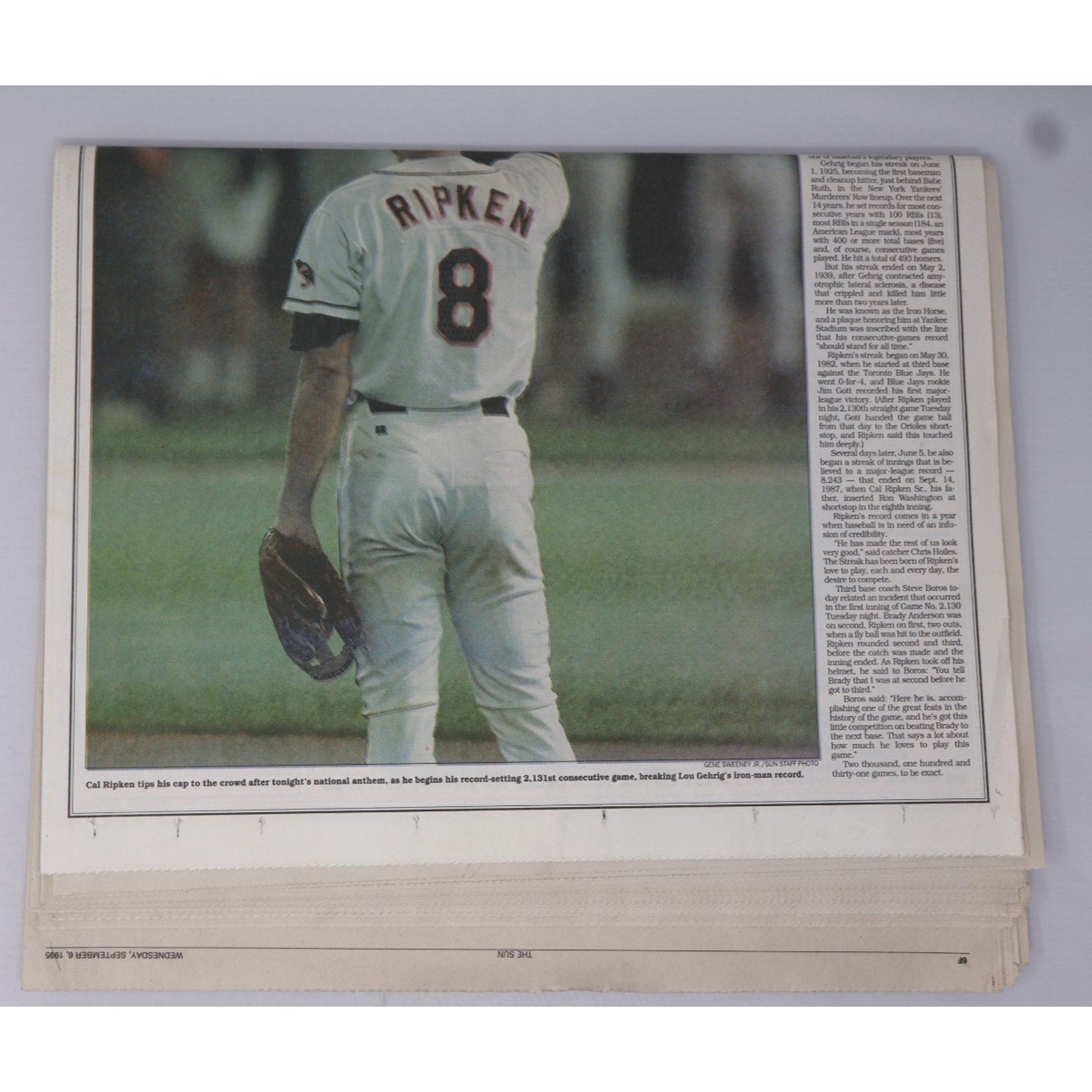 Close-up of vintage Baltimore Sun Stadium Extra newspaper featuring Cal Ripken Jr historic streak-breaking moment