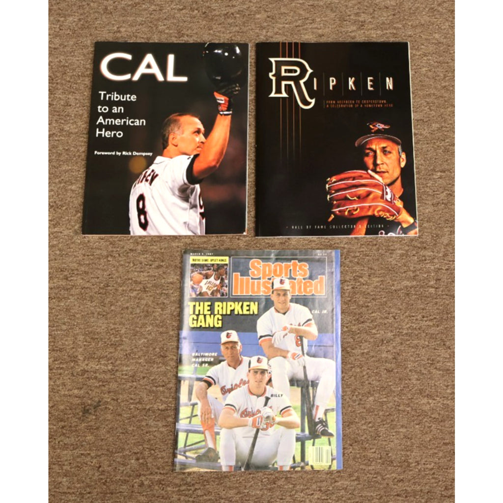 Lot featuring 1987 Sports Illustrated Cal Ripken Jr magazine and tribute books with Baltimore Orioles baseball memorabilia