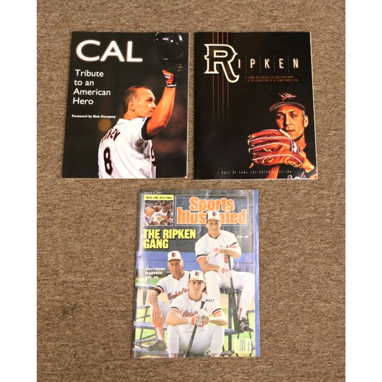 Lot featuring 1987 Sports Illustrated Cal Ripken Jr magazine and tribute books with Baltimore Orioles baseball memorabilia
