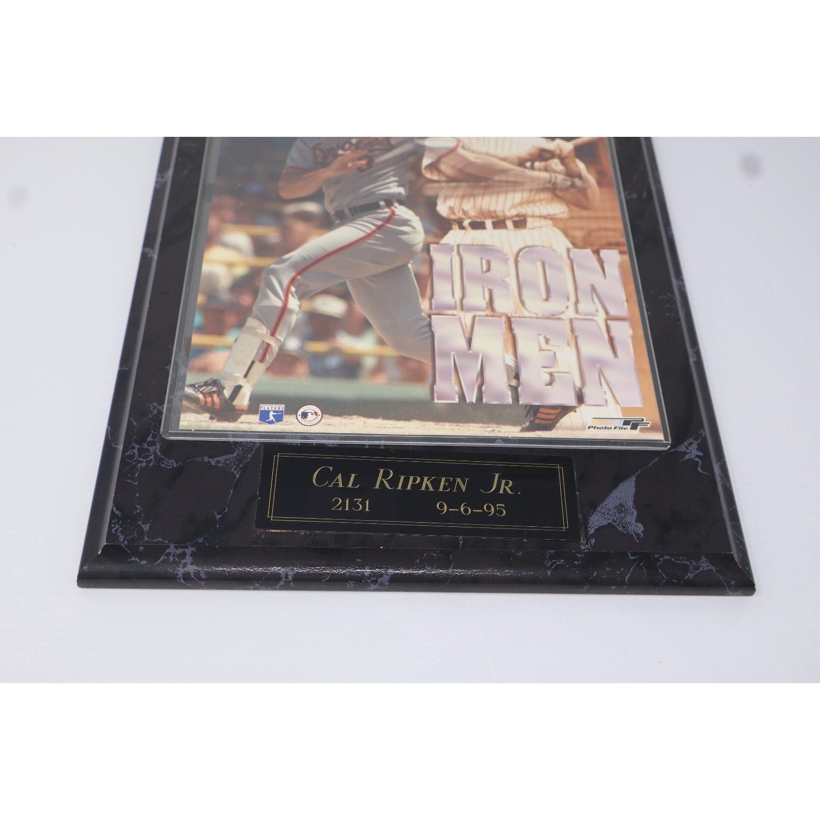 Angled view of Cal Ripken Jr Iron Men wooden plaque with Orioles themed baseball history artwork