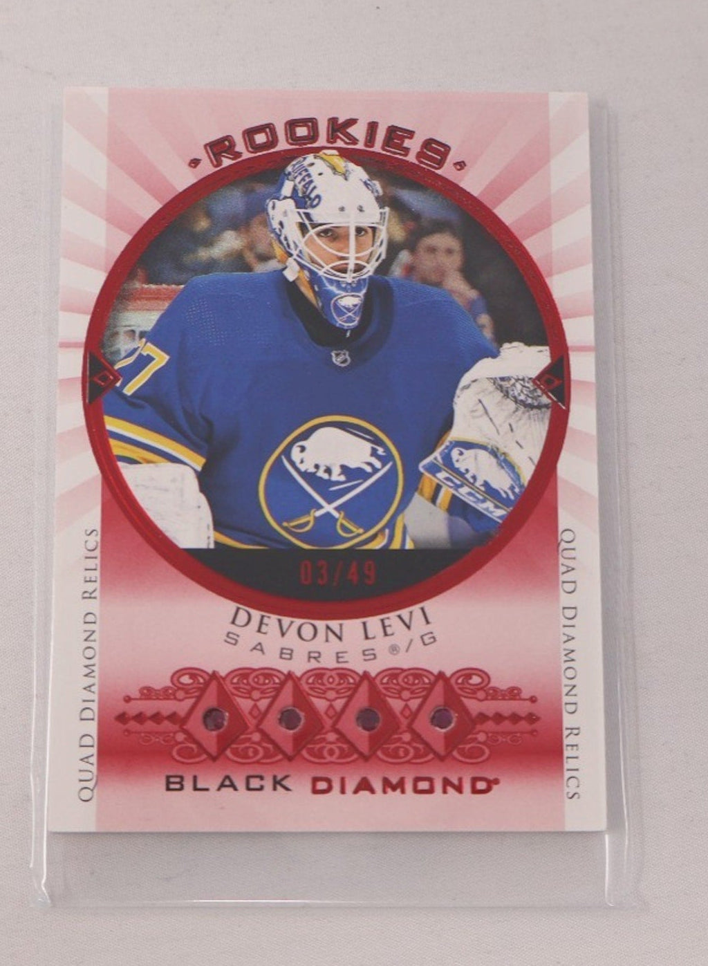 2023-24 UD Black Diamond Devon Levi Rookie Quad Gems Relics Ruby card numbered to 49 featuring Buffalo Sabres rookie goalie