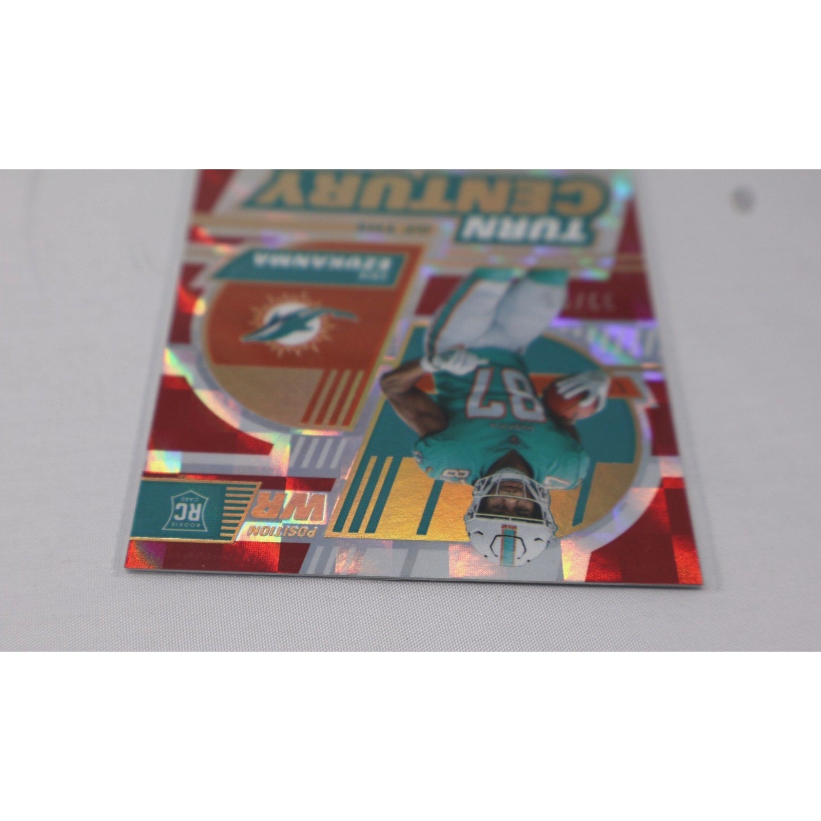 Front angled view of Erik Ezukanma Turn of the Century Red rookie auto card for Miami Dolphins collectors