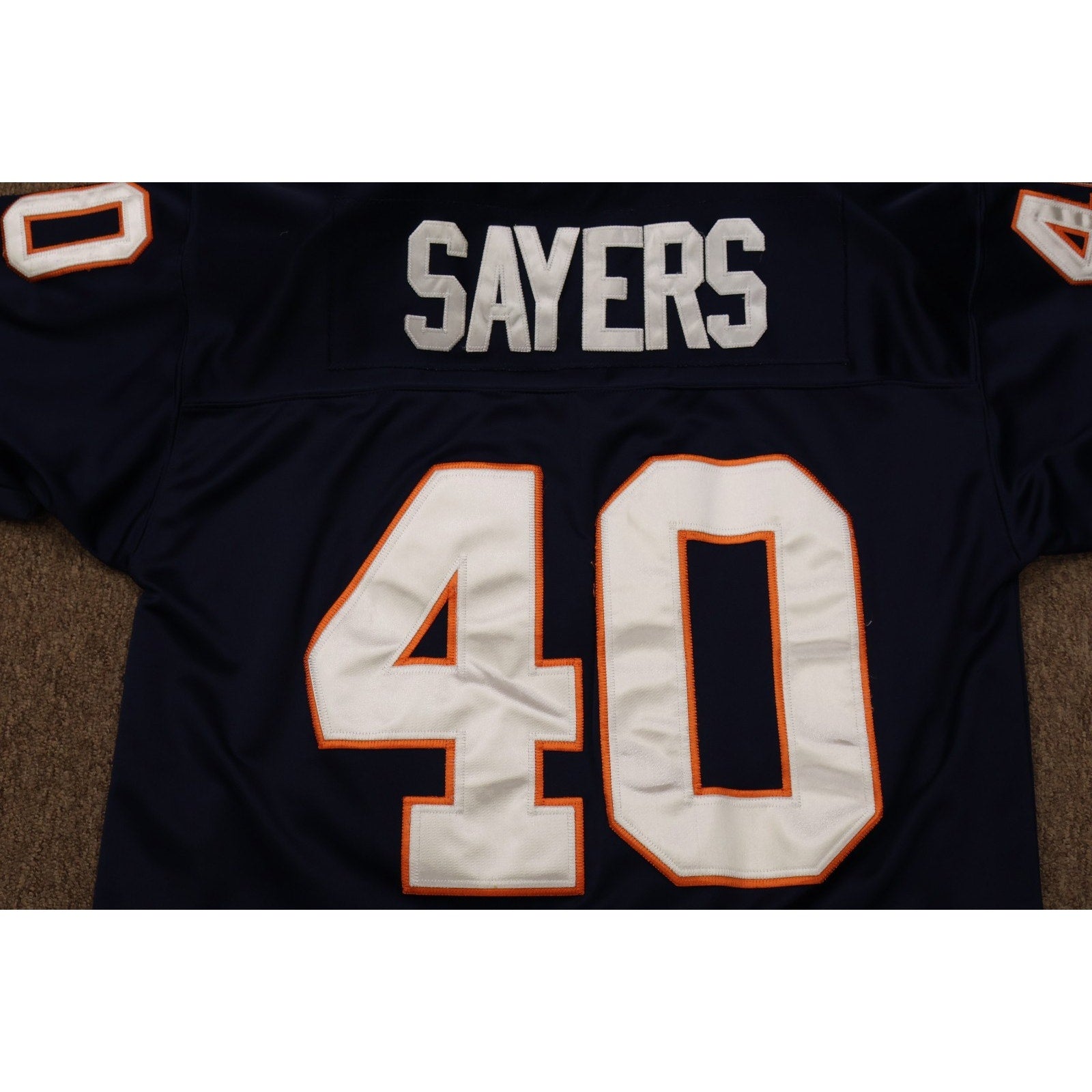 Close-up of Sayers nameplate and number 40 on back of jersey