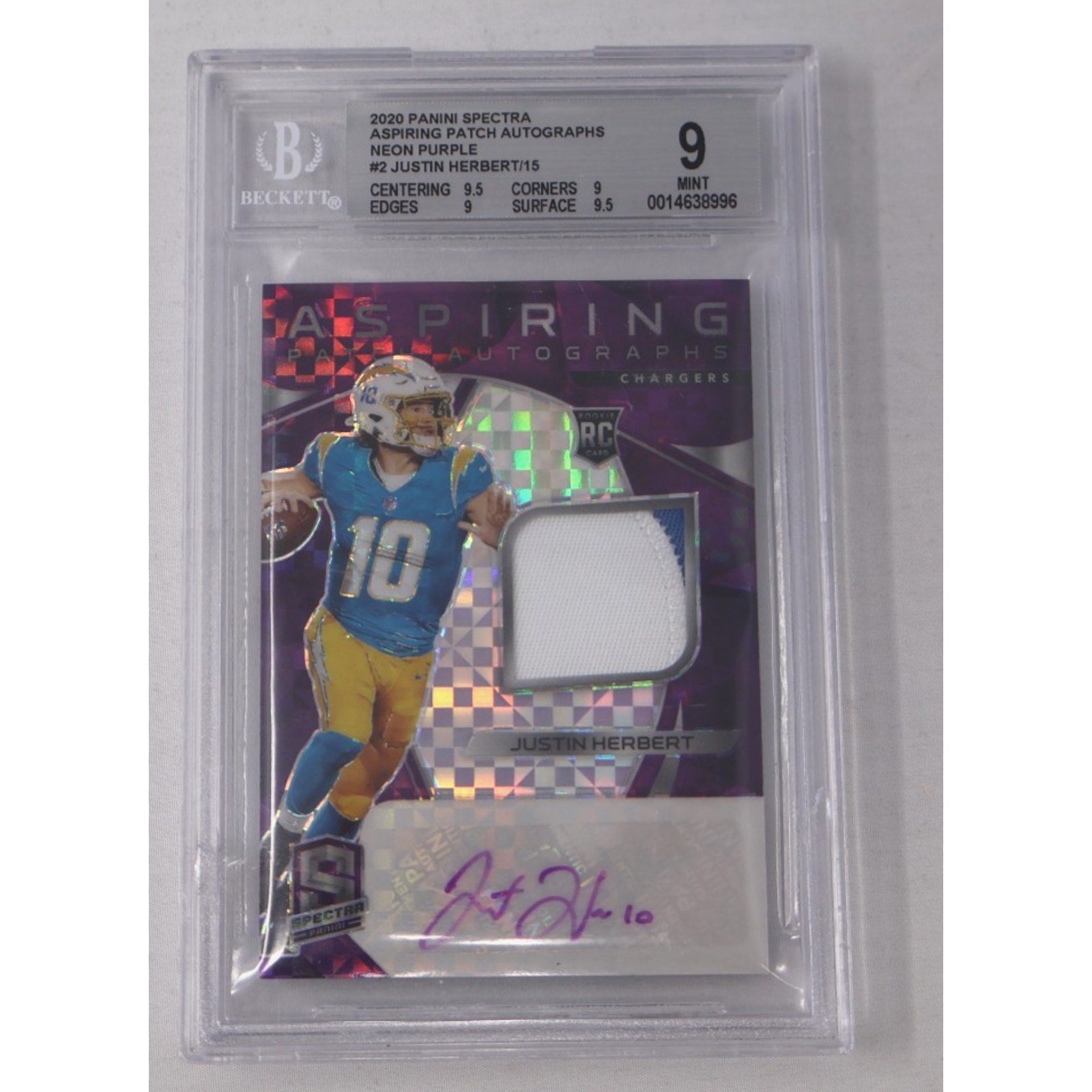 Front view of a 2020 Panini Spectra Justin Herbert Aspiring Patch Autographs Neon Purple rookie card numbered to 15, featuring an autograph and white jersey patch, graded BGS 9