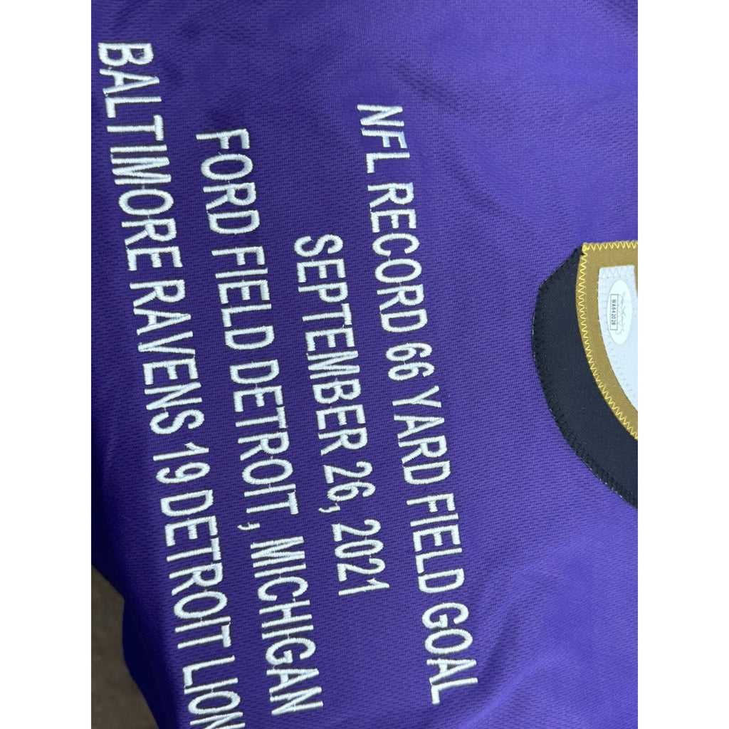 Close-up of embroidered NFL record 66-yard field goal inscription on Ravens jersey