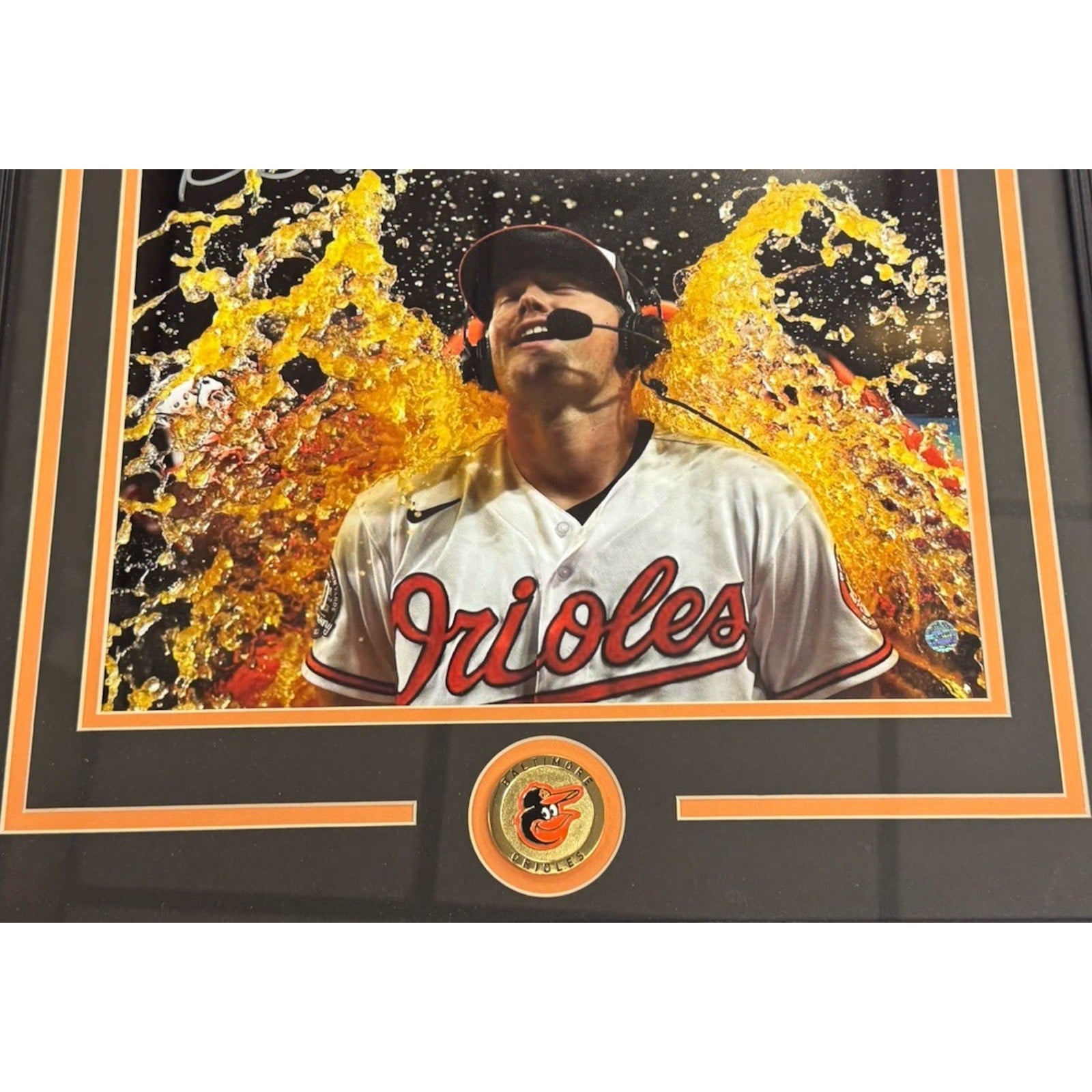 Baltimore Orioles logo and framed Kyle Bradish memorabilia display