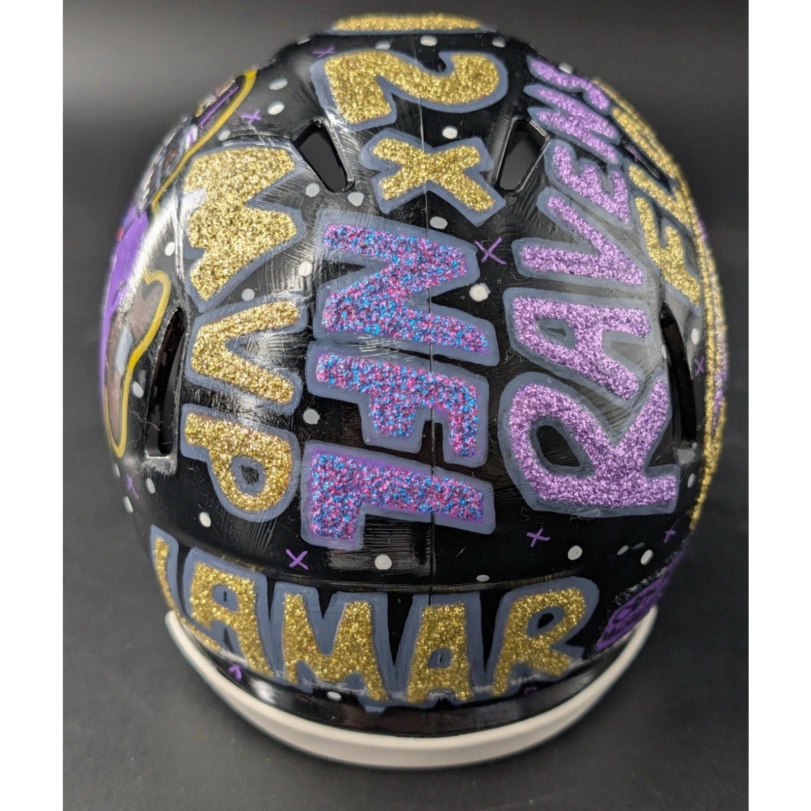 Top view of Lamar Jackson 1/1 painted art helmet featuring custom Ravens graphics and lettering