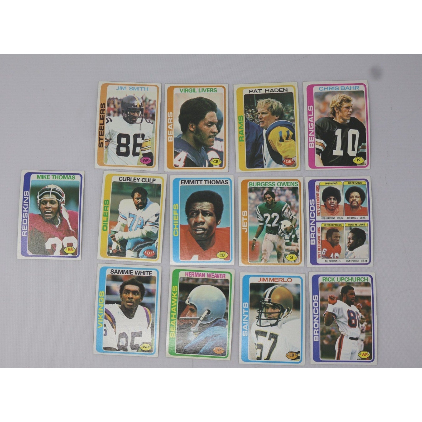 Lot of 13 vintage 1978 Topps football cards featuring NFL players including Emmitt Thomas and other classic stars from the late 1970s