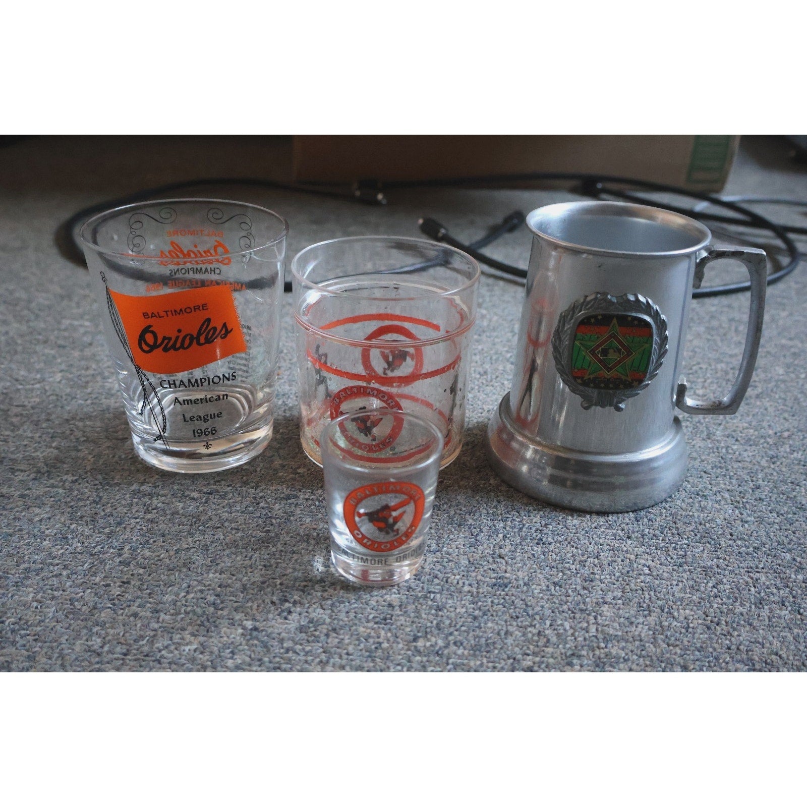 Lot of vintage Baltimore Orioles cups and shot glasses including 1966 American League Champions commemorative mug