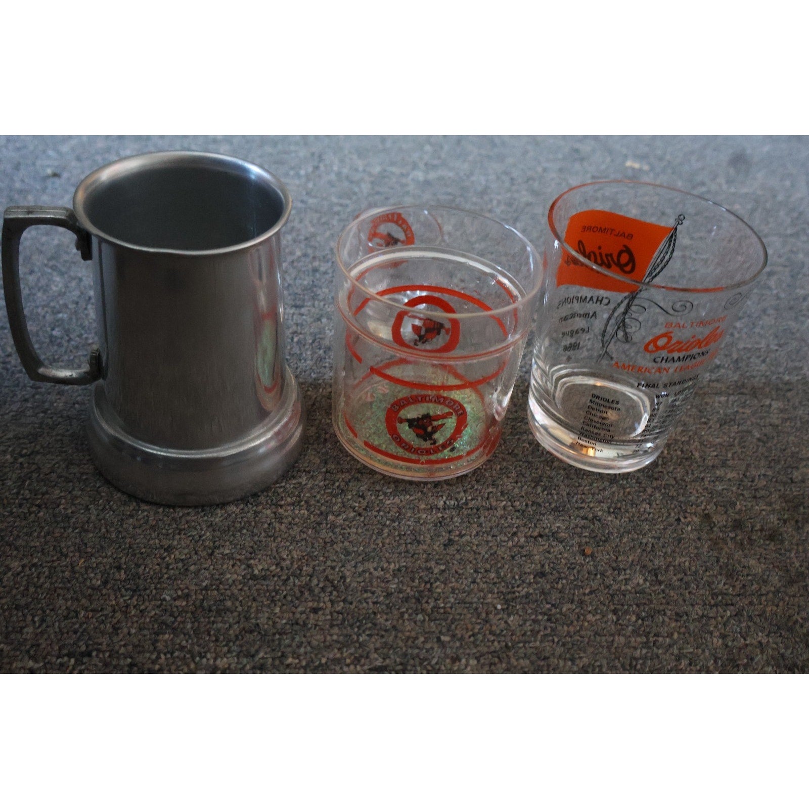 Vintage Baltimore Orioles collectible drinkware set with Orioles shot glasses and commemorative mug