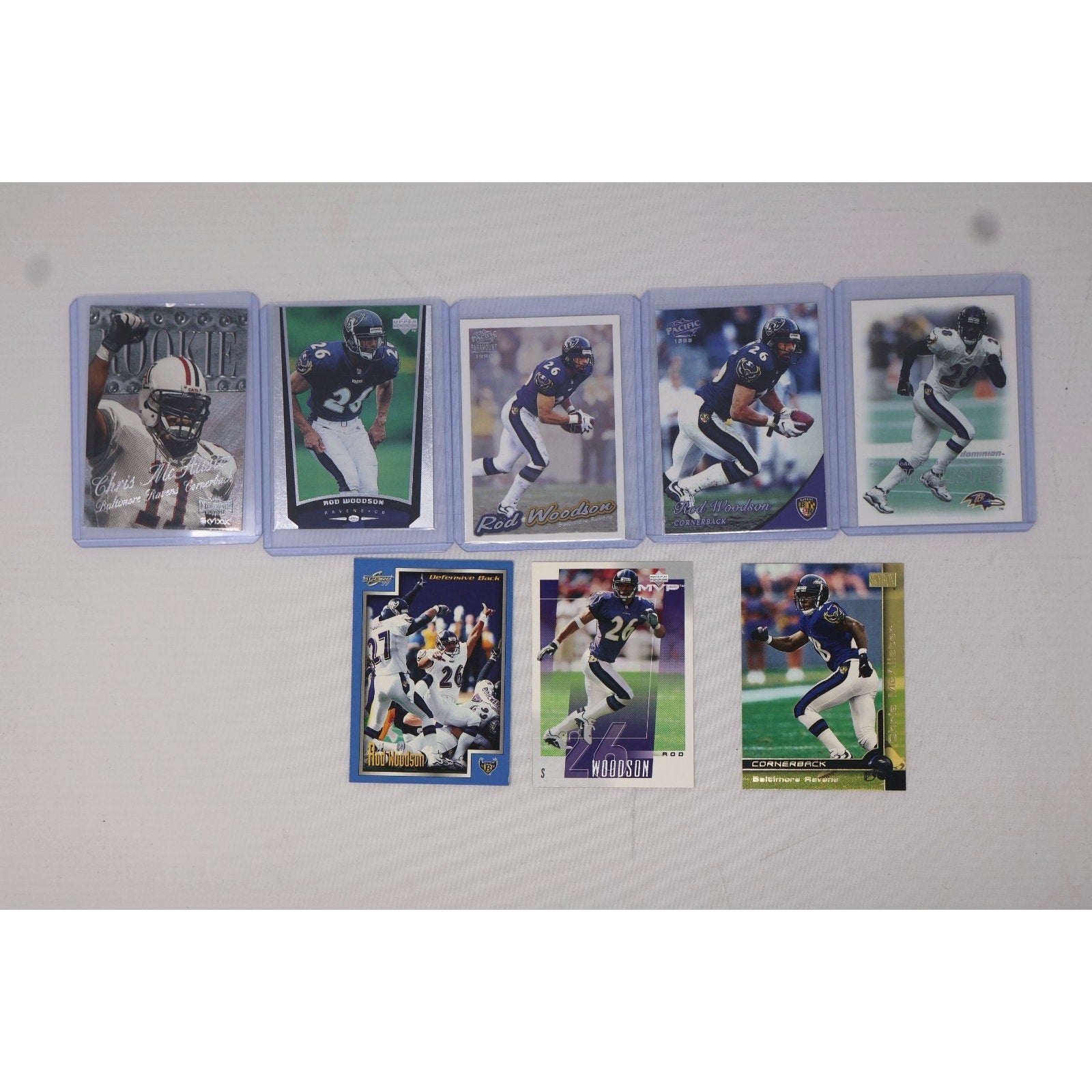 Lot of 8 Baltimore Ravens football insert trading cards featuring Rod Woodson and Chris McAlister from various NFL card releases in Near Mint condition