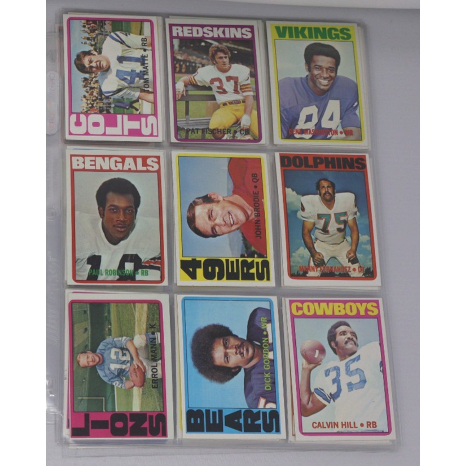 Lot of 9 vintage 1972 Topps football cards featuring NFL stars and Hall of Fame players including Fernandez, John Brodie, Calvin Hill, and players from the Redskins, Vikings, Dolphins, Bengals, and Cowboys