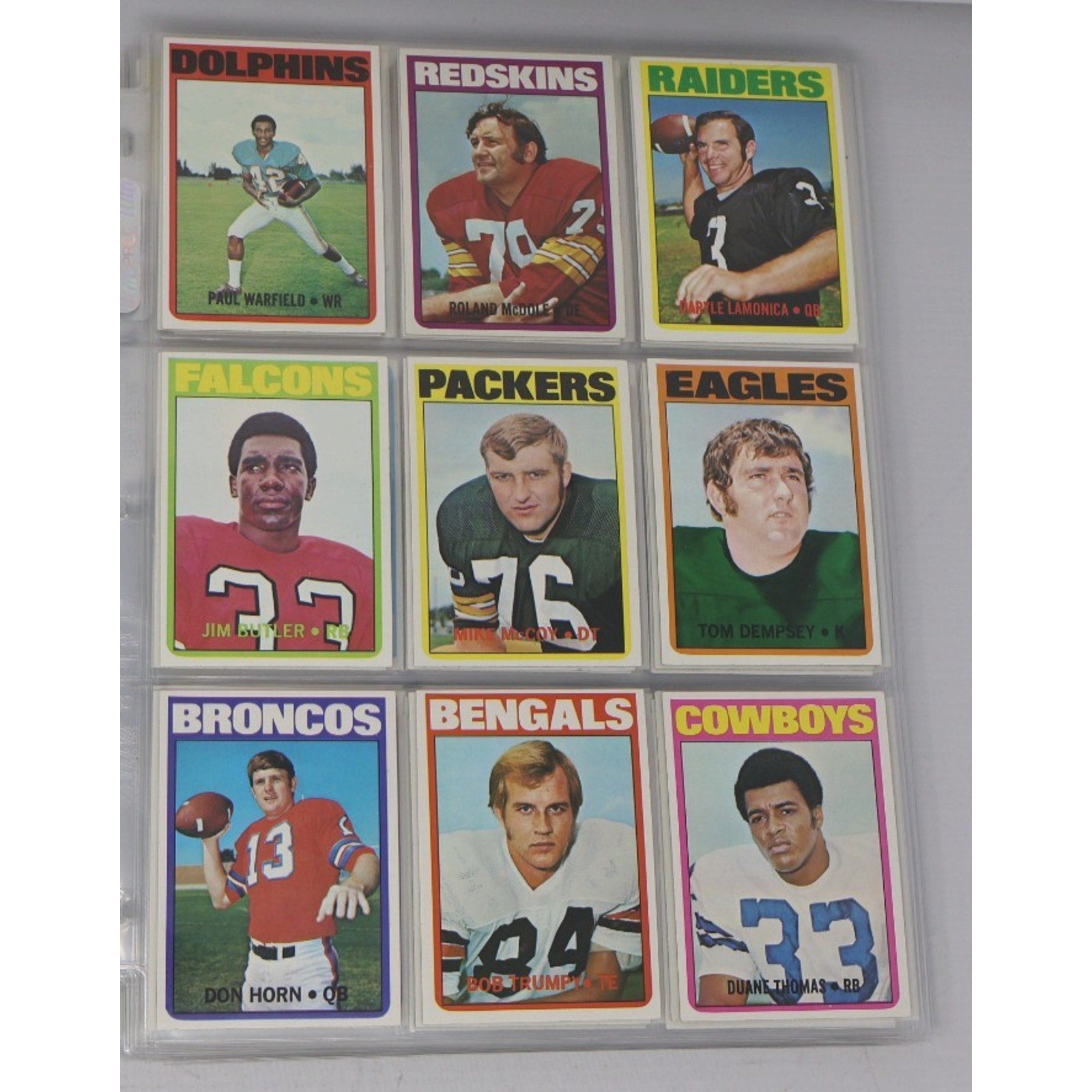 Lot of 9 vintage 1972 Topps football cards featuring NFL Hall of Fame players including Paul Warfield, Tom Dempsey, and Duane Thomas