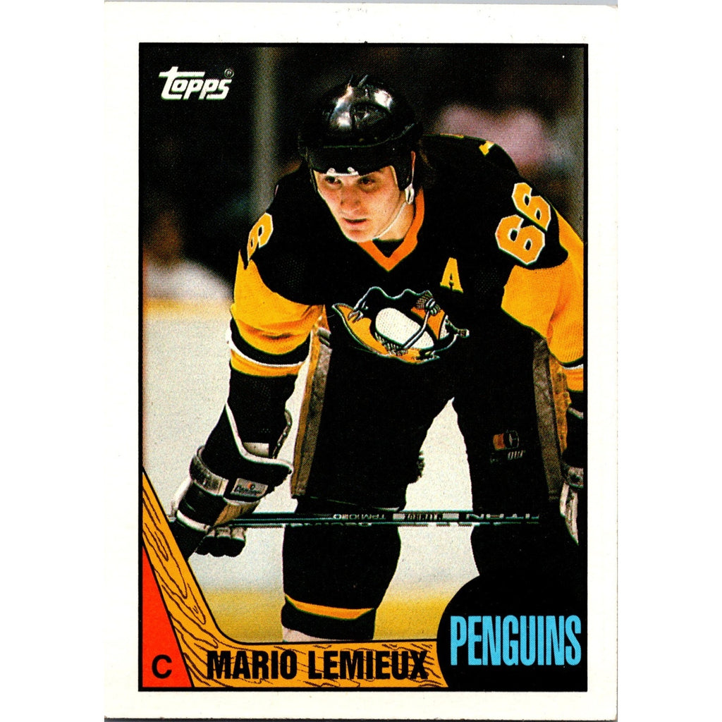 1987-88 Topps Mario Lemieux #15 hockey trading card featuring the Pittsburgh Penguins legend in black and gold uniform