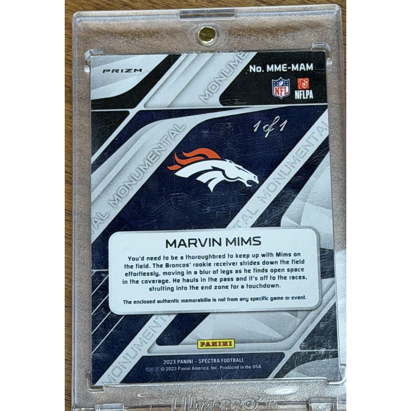 Back view of the 2023 Panini Spectra Marvin Mims rookie card displaying player information, authenticity details, and Panini branding