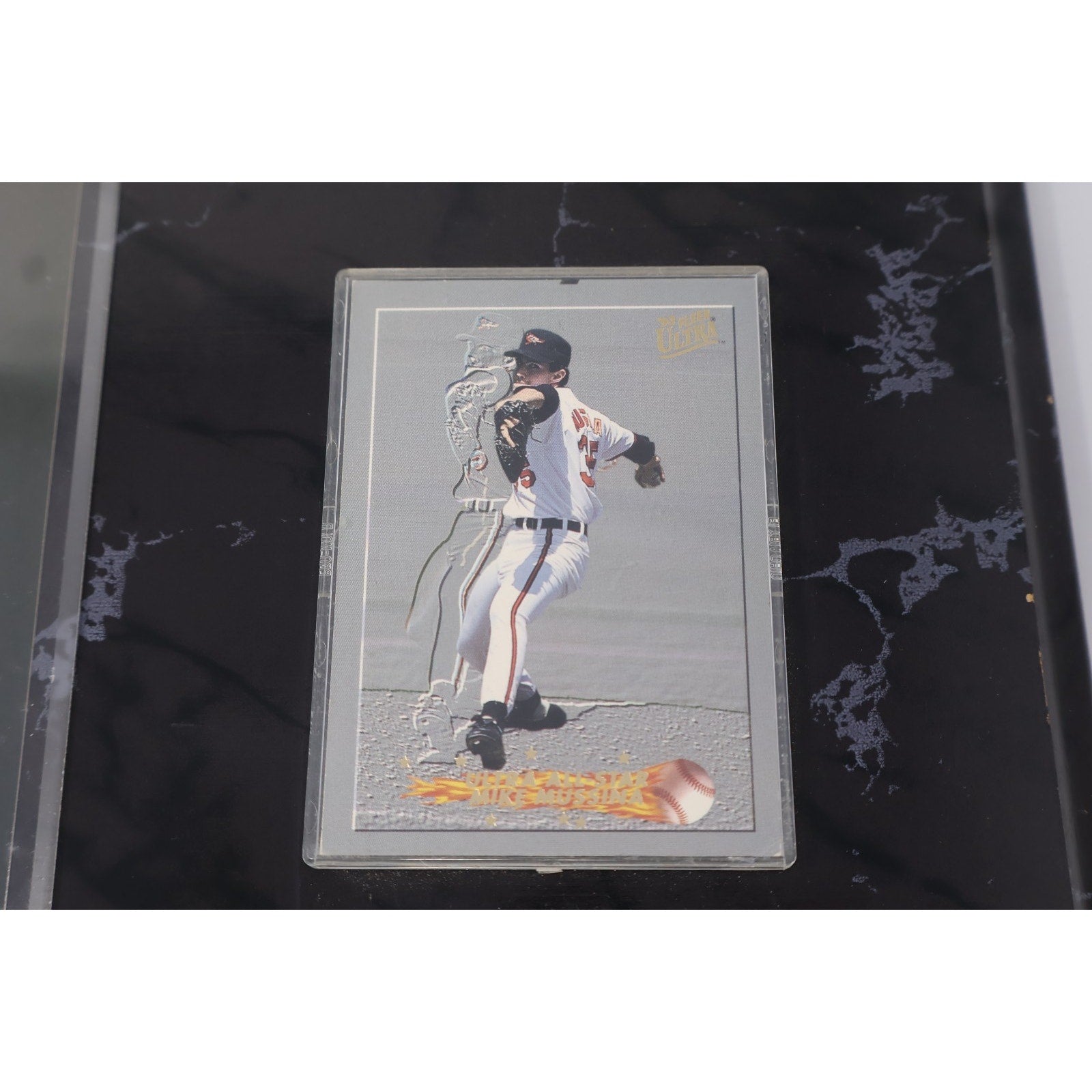 Detailed view of embedded Mike Mussina baseball card mounted on Orioles memorabilia plaque