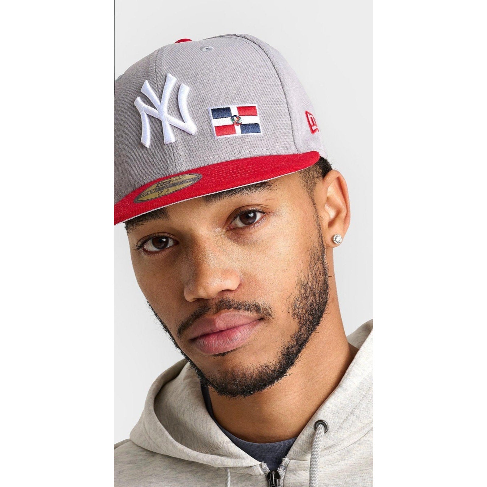 Model wearing New Era New York Yankees Dominican Republic 59FIFTY fitted cap in gray and red