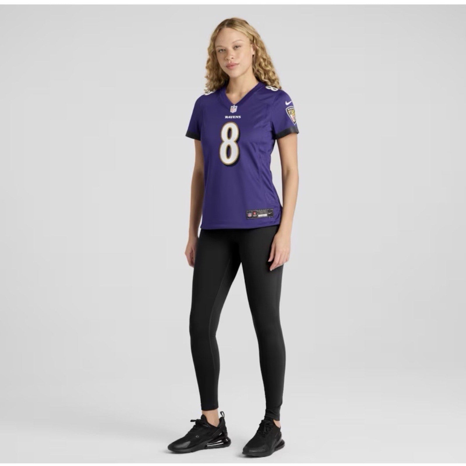 Model wearing Lamar Jackson Baltimore Ravens women’s Nike jersey in purple