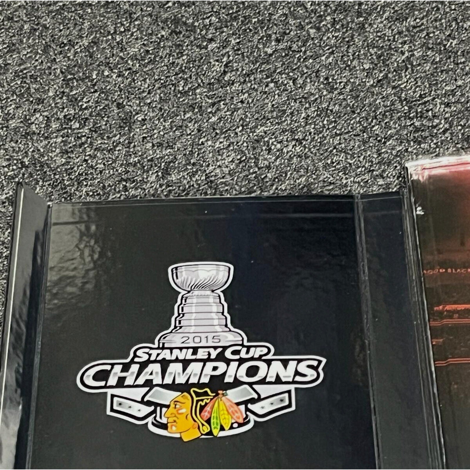Champions commemorative branding on Chicago Blackhawks One Goal Achieved III display case