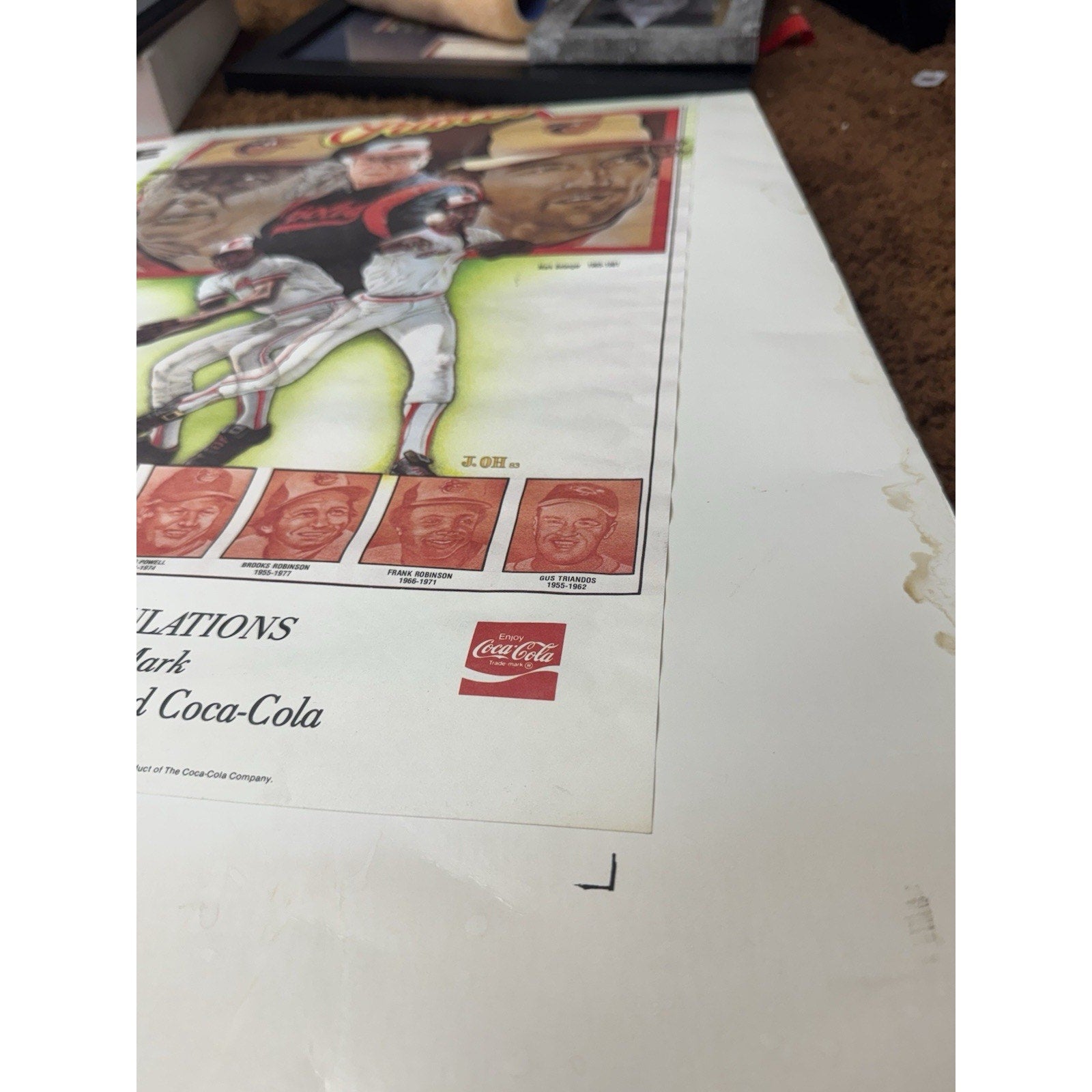 Close-up of Coca-Cola branding and Orioles Hall of Fame text on poster