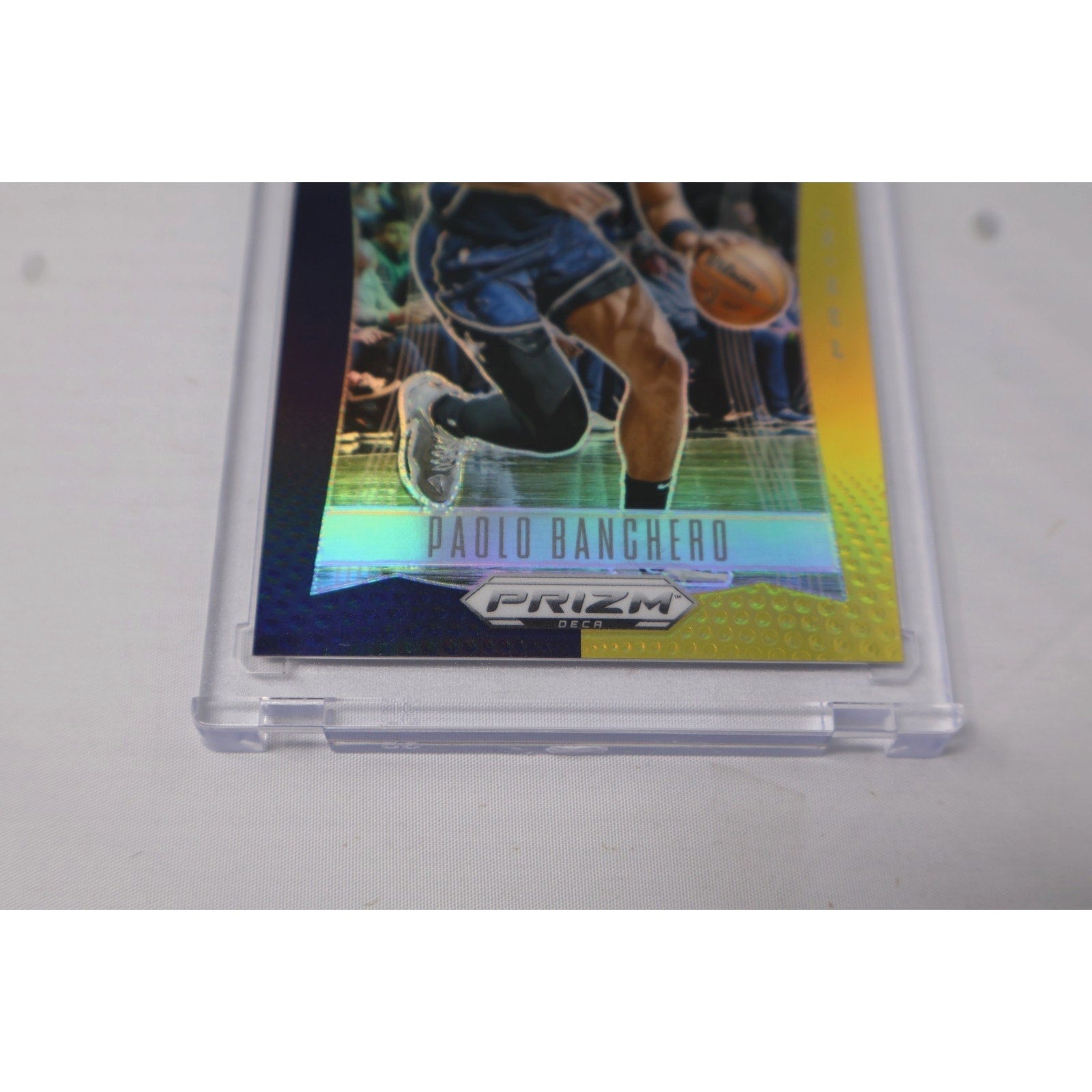 Angled front view of Paolo Banchero Prizm Deca Black Gold parallel rookie card in protective holder